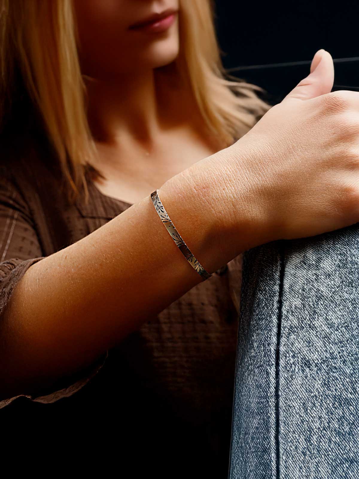 a woman wearing a bracelet on her wrist