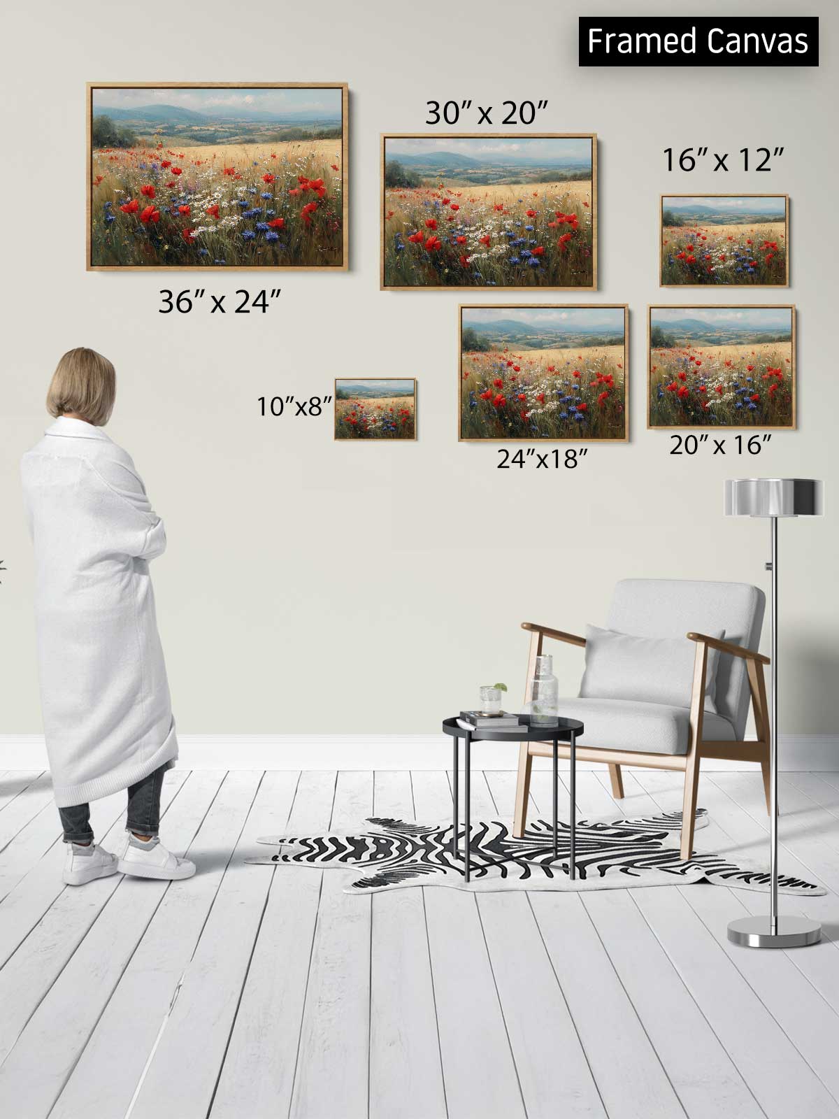 a person standing in a room, looking at a collection of framed canvas paintings on the wall. The paintings depict various landscapes, including fields of flowers. The person appears to be examining the different sizes of the paintings, which are arranged in a grid-like pattern on the wall.