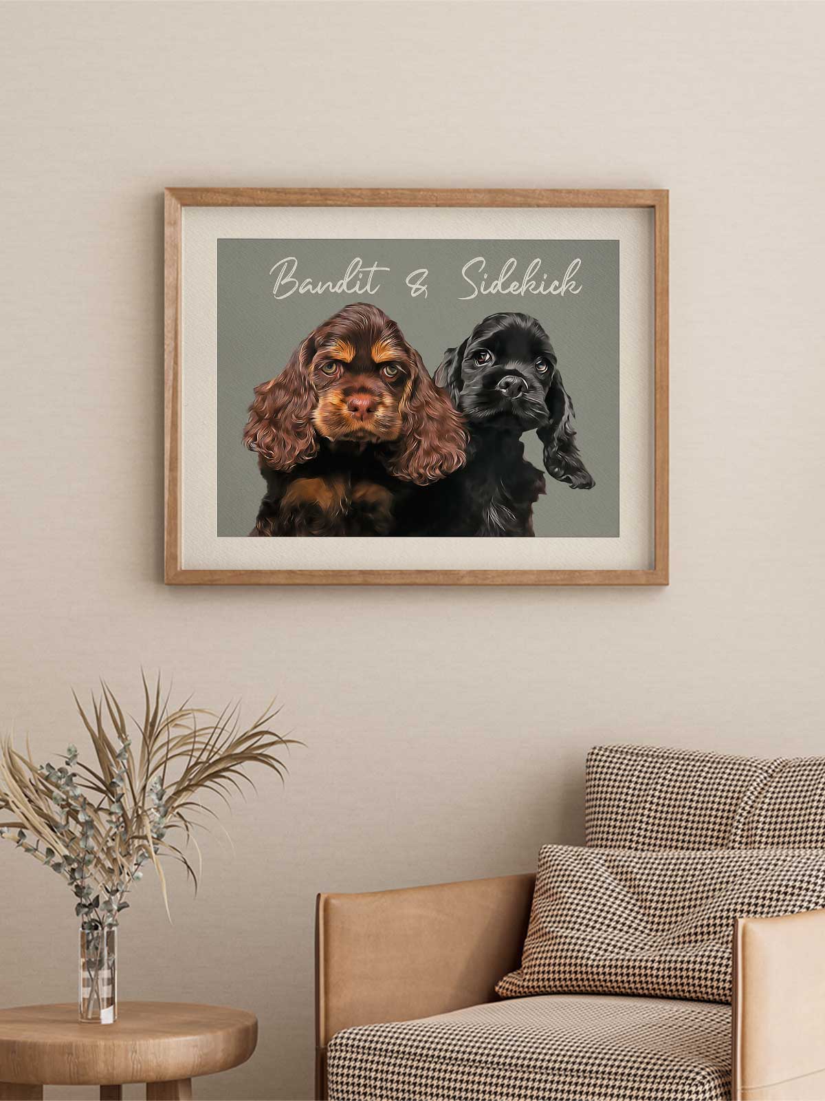 two dogs, one brown and one black, sitting together in a framed picture hanging on a wall.