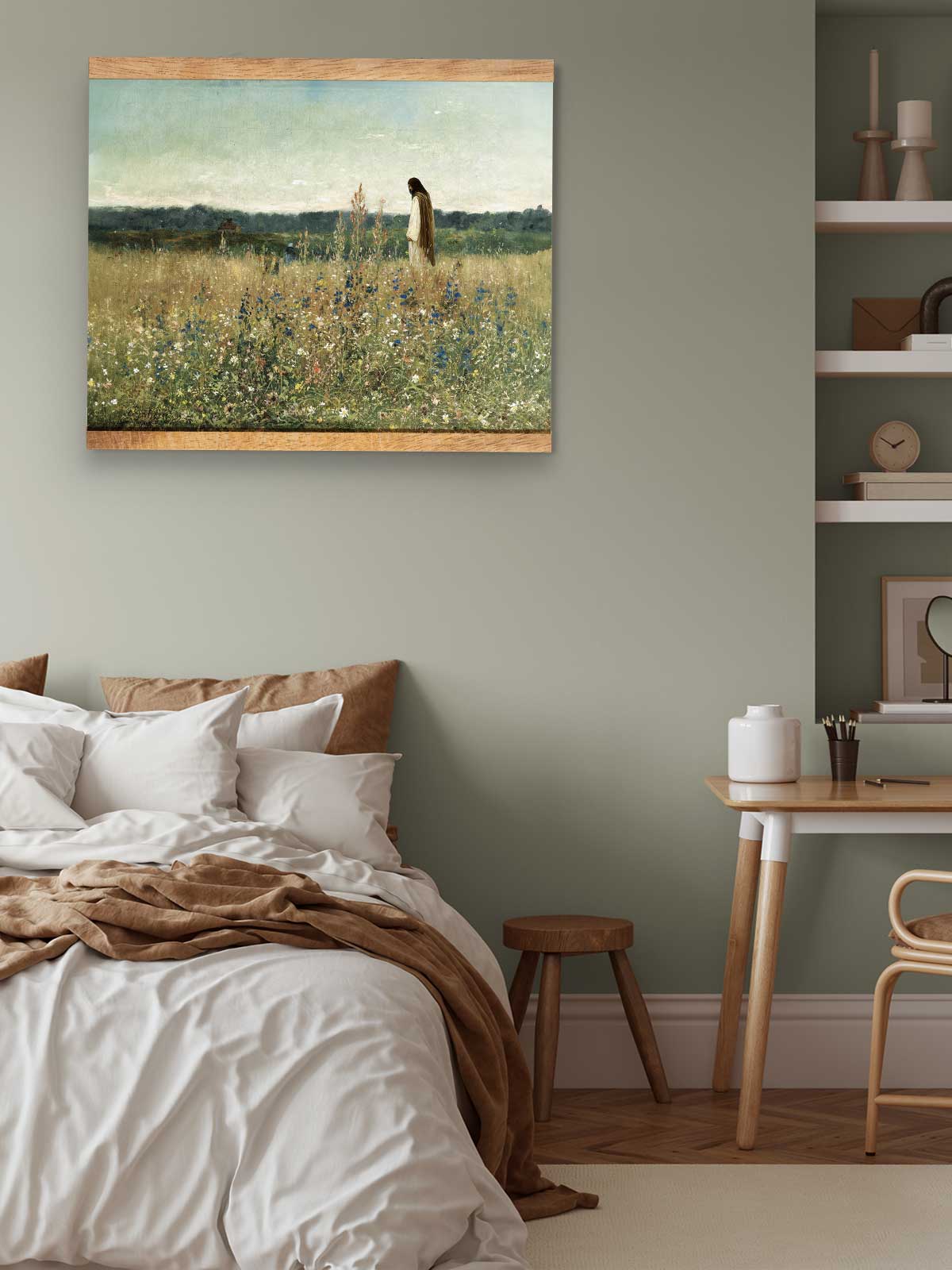 a serene bedroom scene with a bed, a wooden table, and a painting of a woman in a field of flowers hanging on the wall.