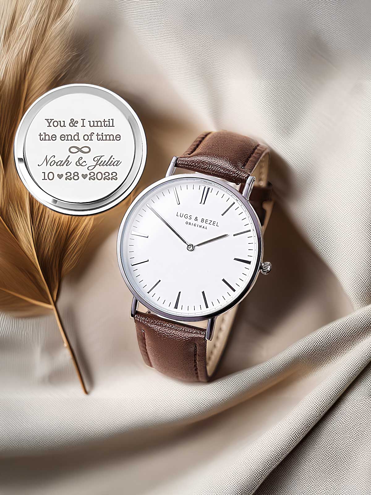 a couple of watches sitting on top of a white cloth