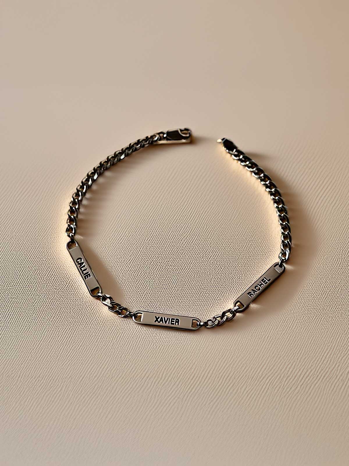 a silver bracelet with a name engraved on it