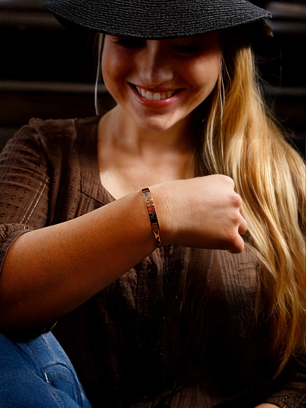 a woman wearing a hat and a bracelet