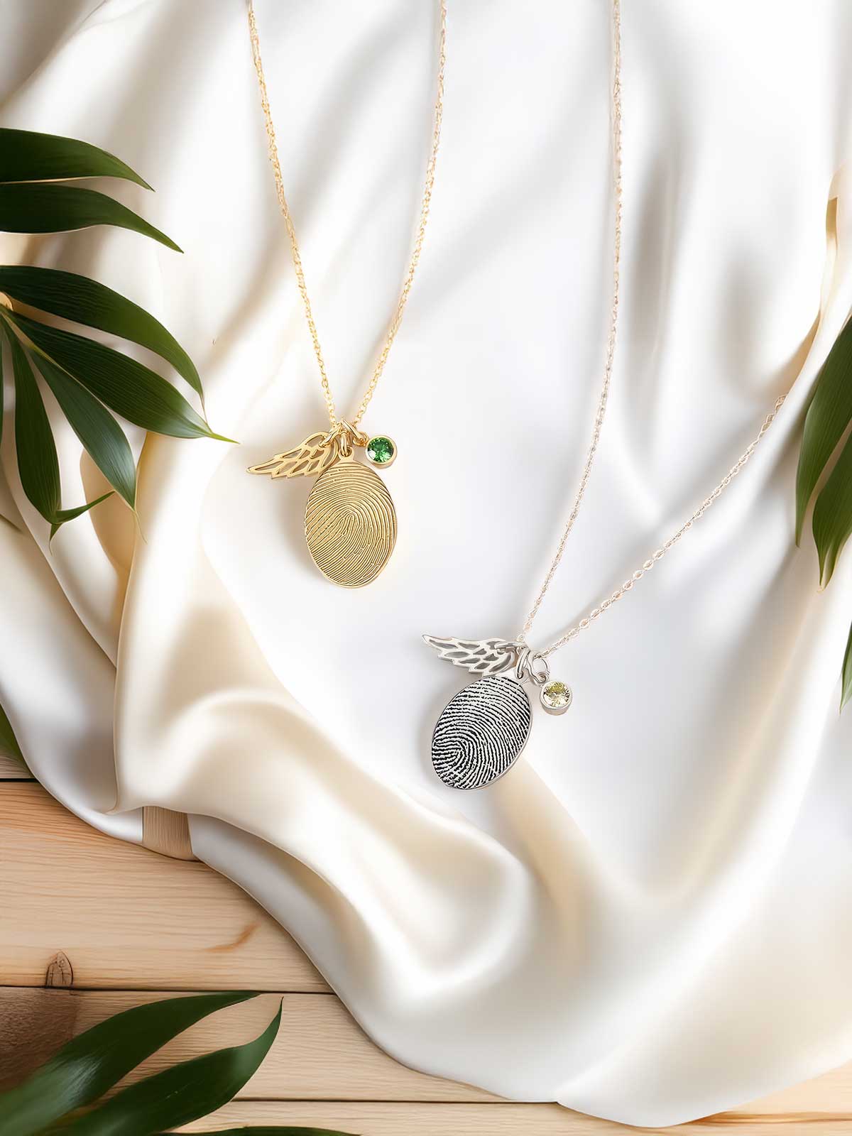 two necklaces with a pineapple and a fingerprint on them