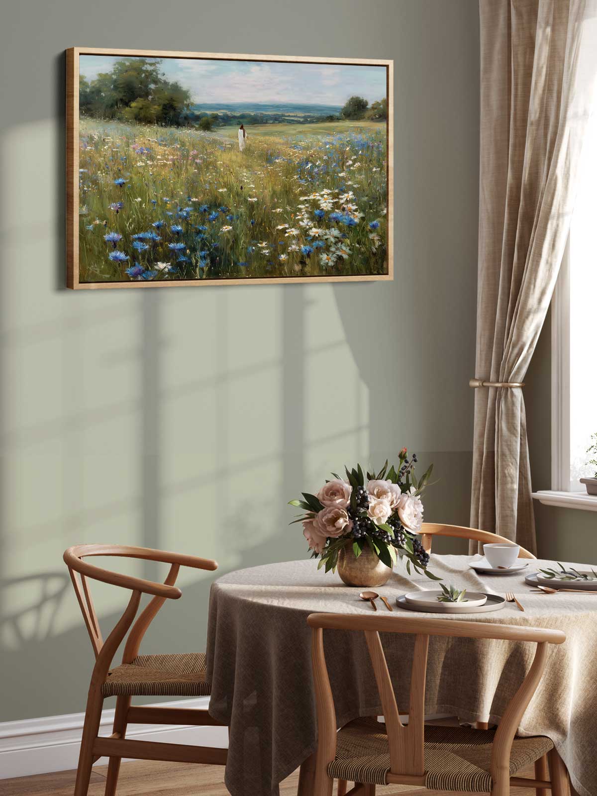 a dining room with a table set for two, a vase of flowers, and a painting of a field of flowers hanging on the wall above the table.