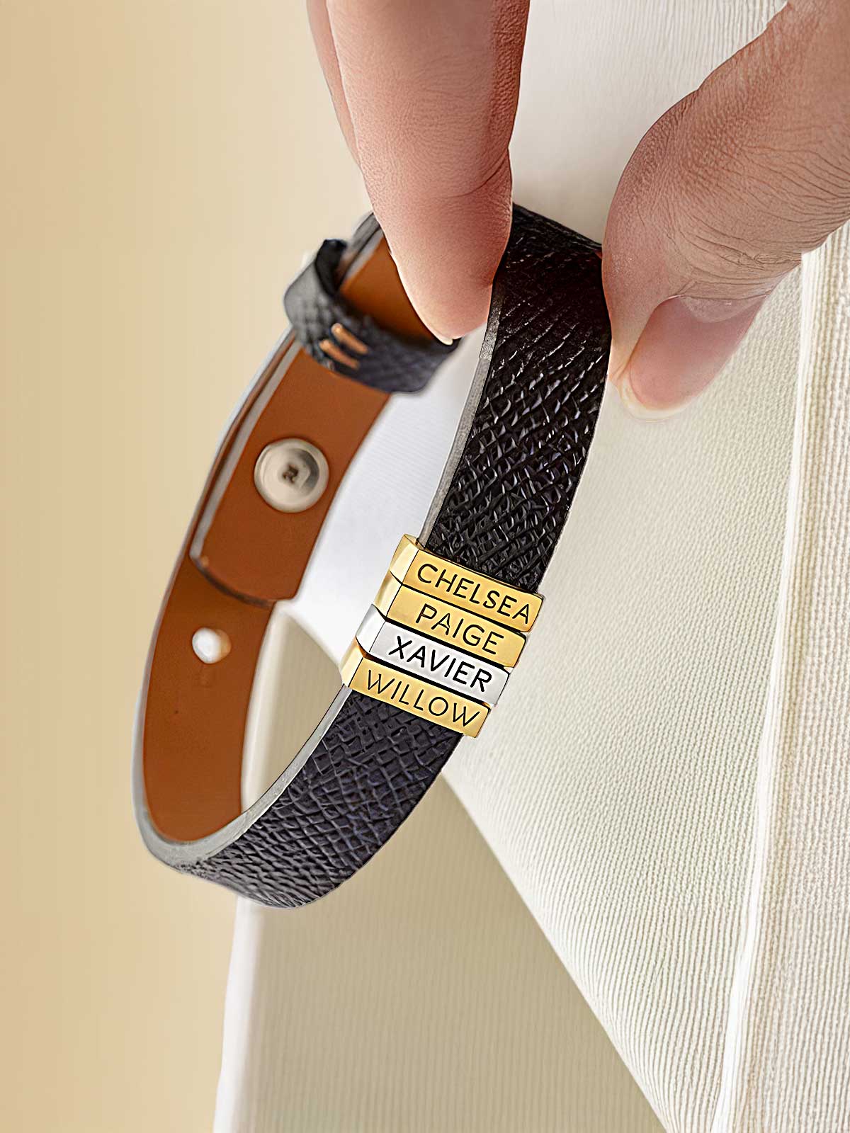 a person holding onto a belt with a tag on it