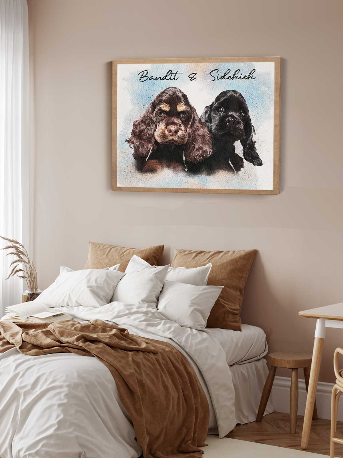 two dogs, one brown and one black, sitting together in a framed artwork on the wall above a bed with white sheets and brown pillows.