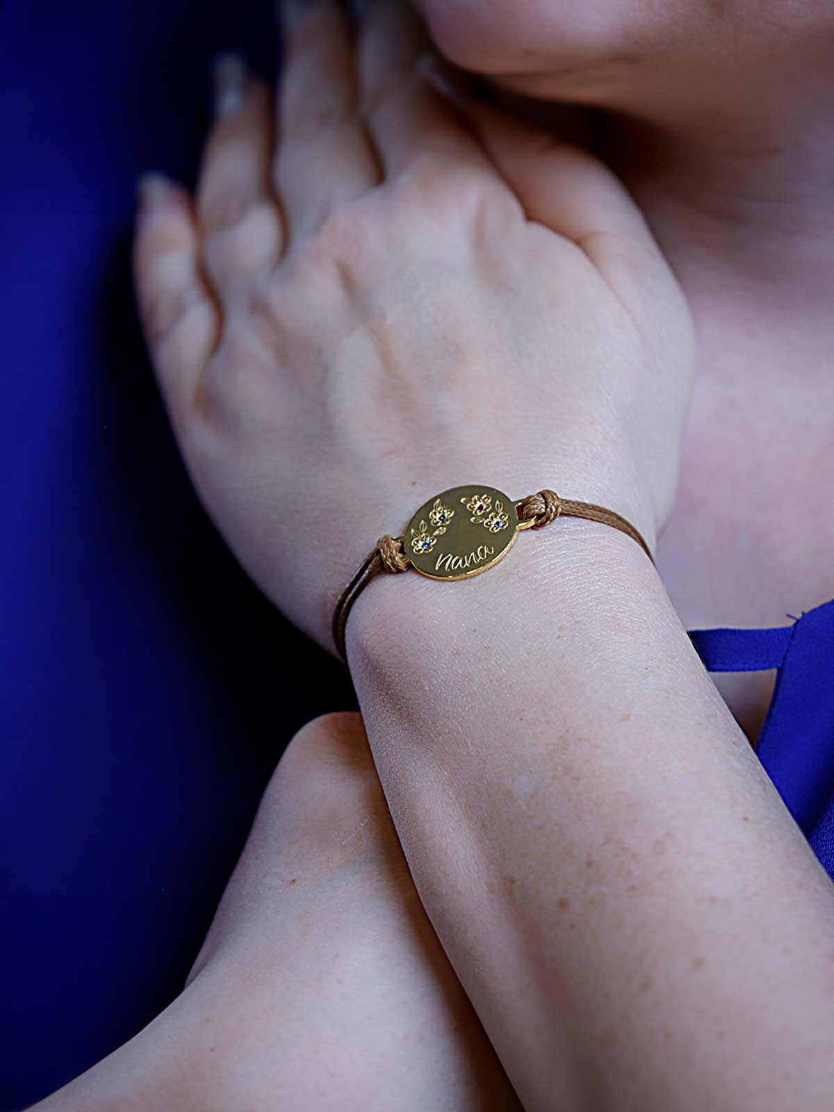 a woman wearing a blue dress and a gold bracelet