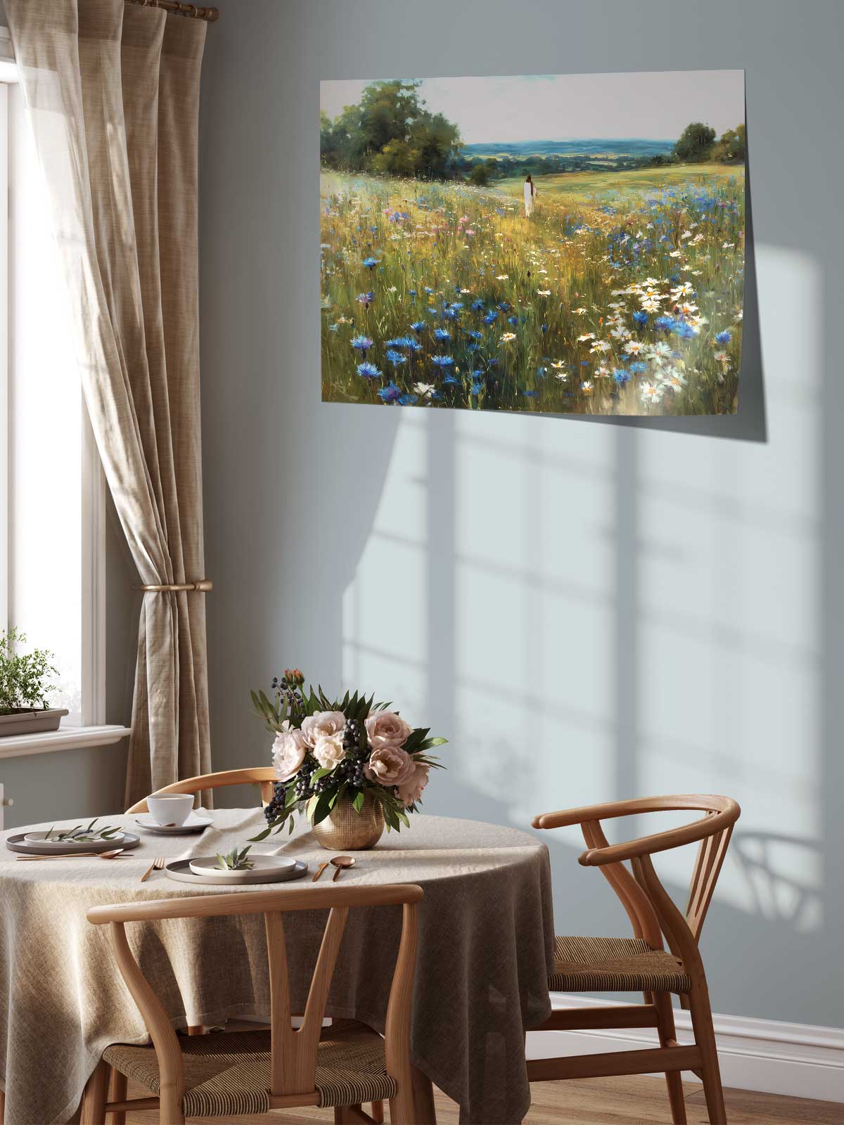 a serene dining room with a table set for two, featuring a vase of flowers and a painting of a field of flowers hanging on the wall above it.
