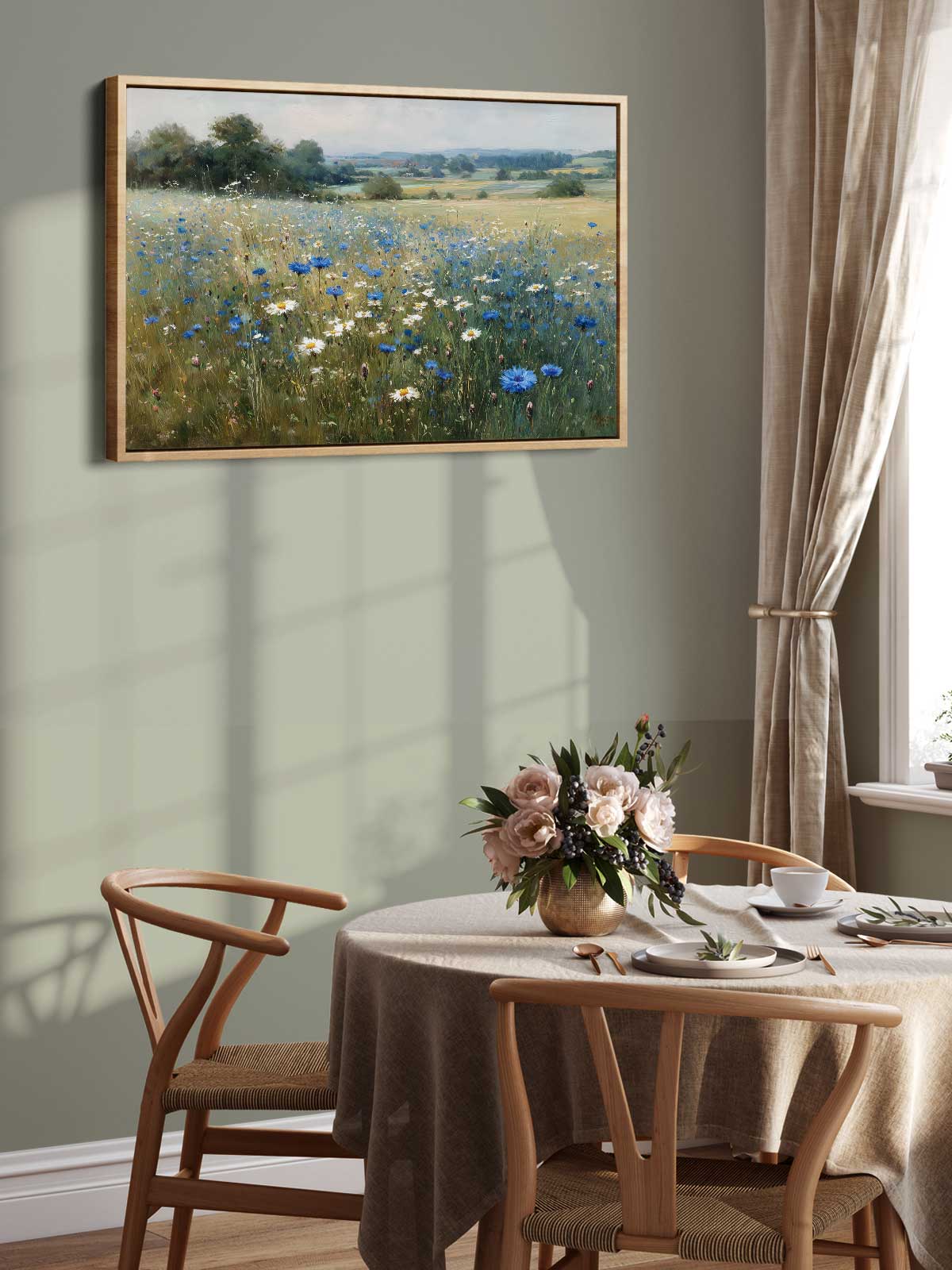 a dining room with a table set for two, a vase of flowers, and a painting of a field of flowers hanging on the wall above the table.