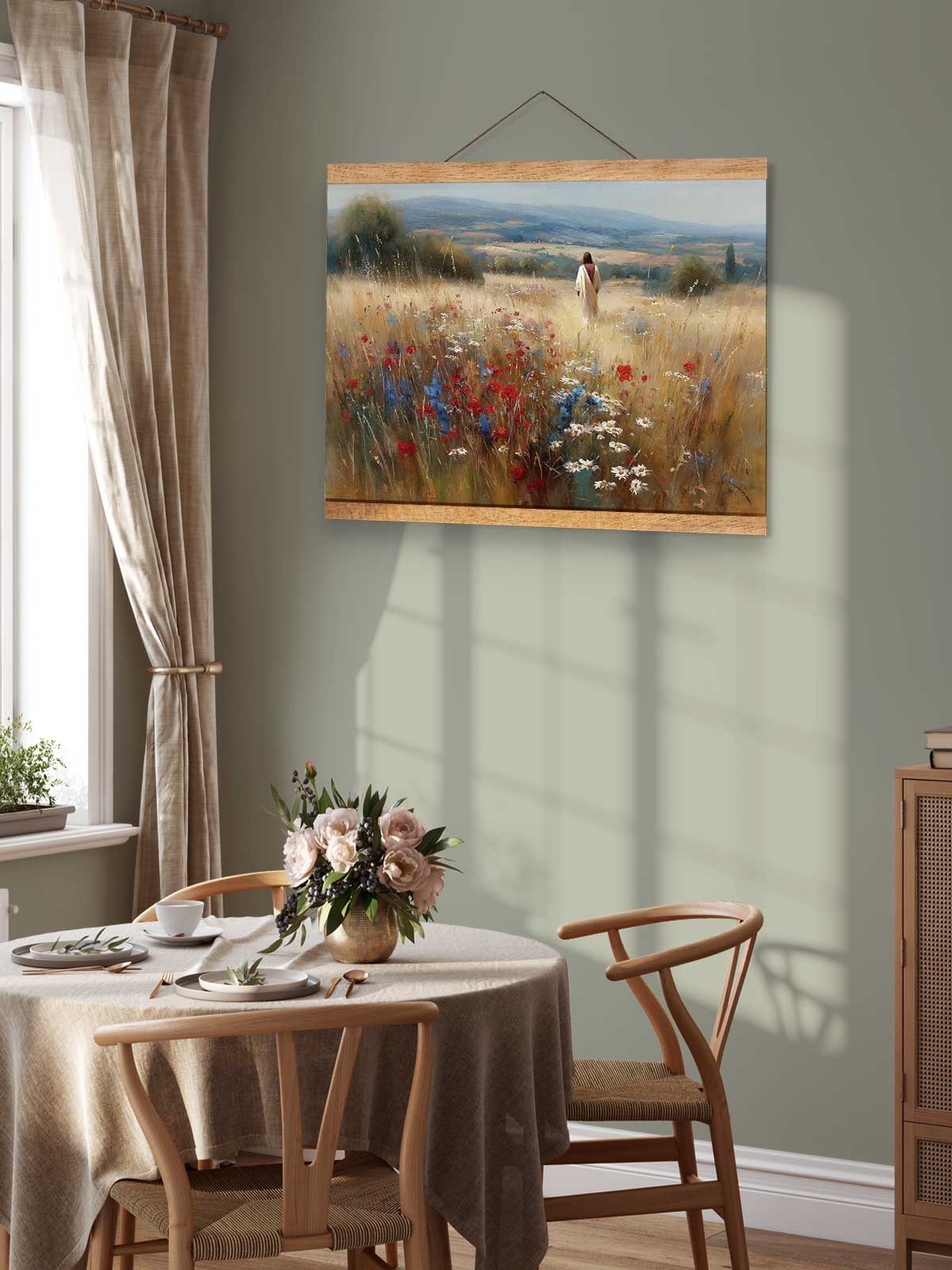 a serene dining room with a table set for two, featuring a vase of flowers and a painting of a field with wildflowers hanging on the wall above the table.