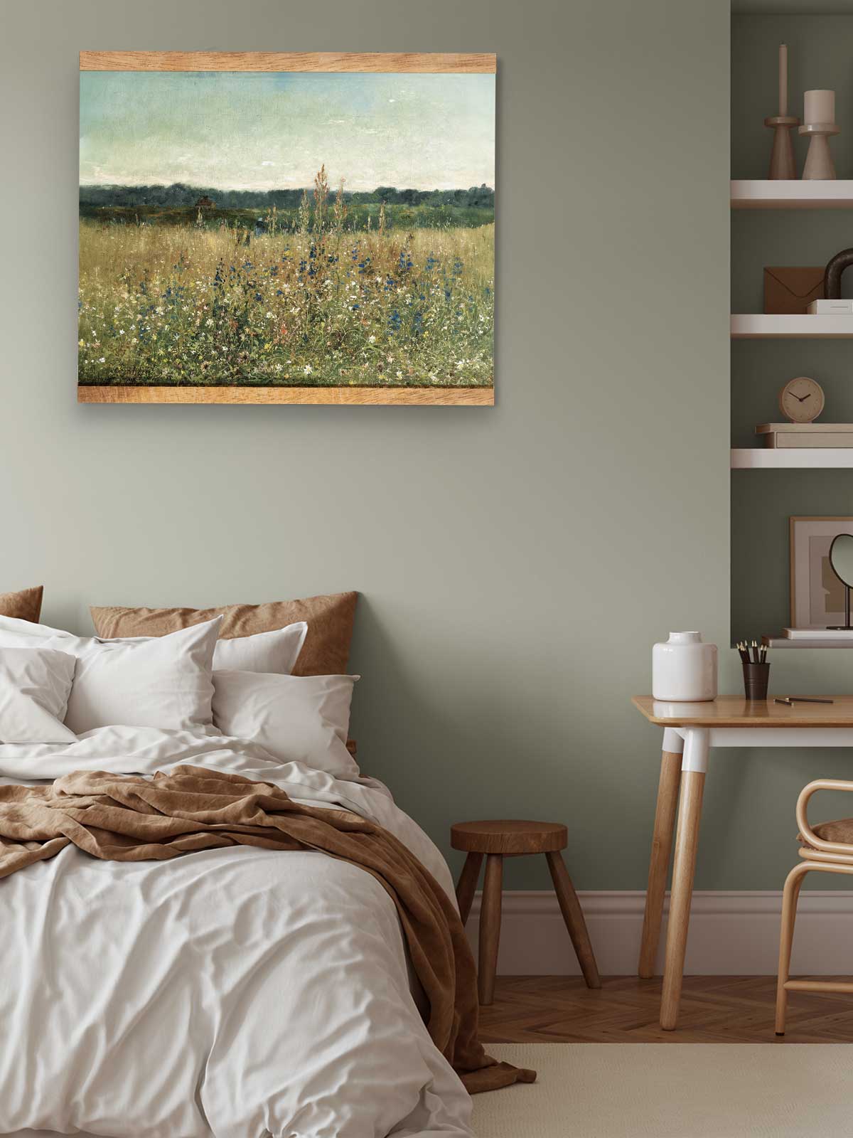 a serene bedroom scene with a large bed, a wooden table, and a painting of a field of flowers hanging on the wall.