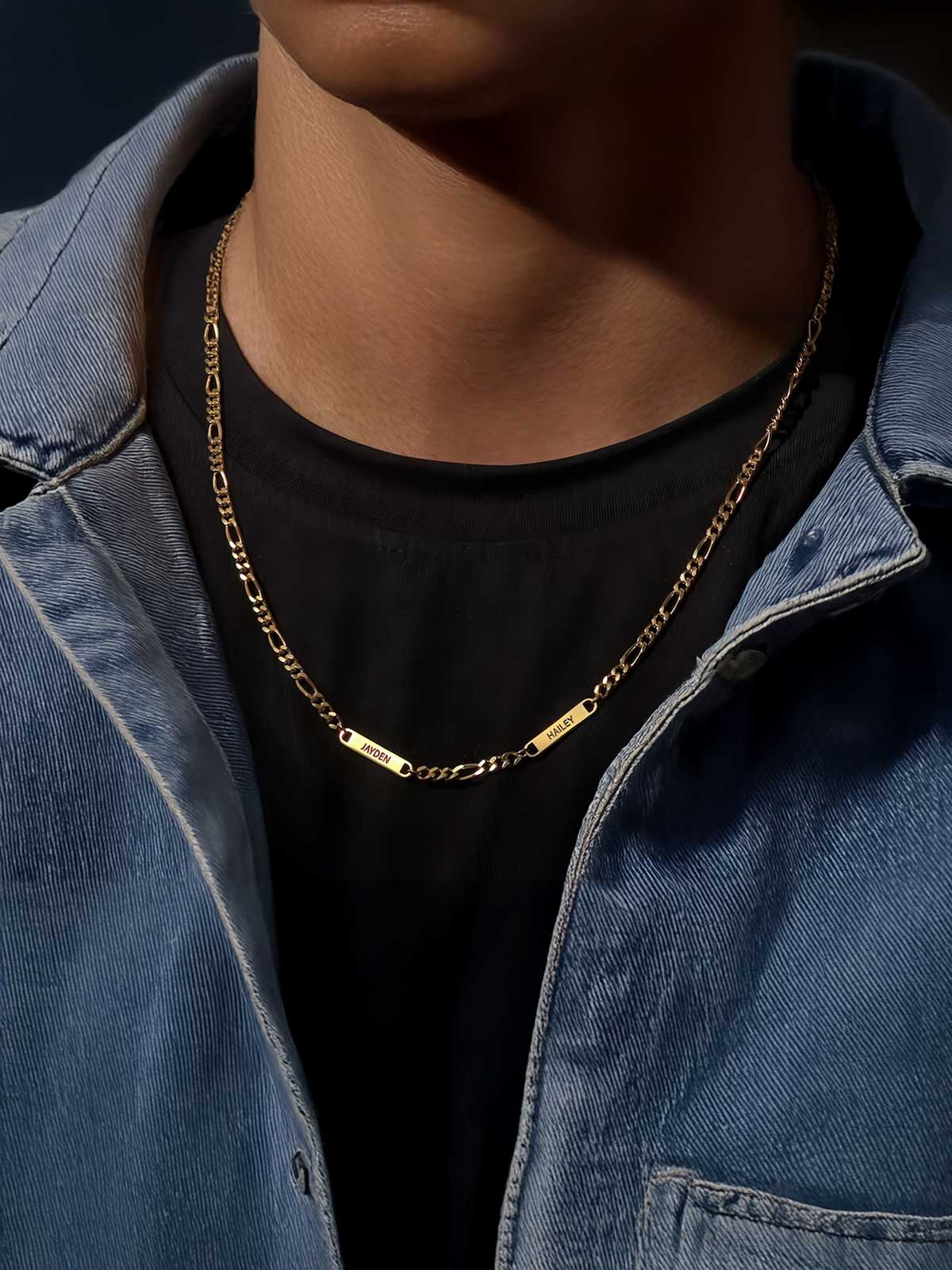 a man wearing a black shirt and a gold chain necklace