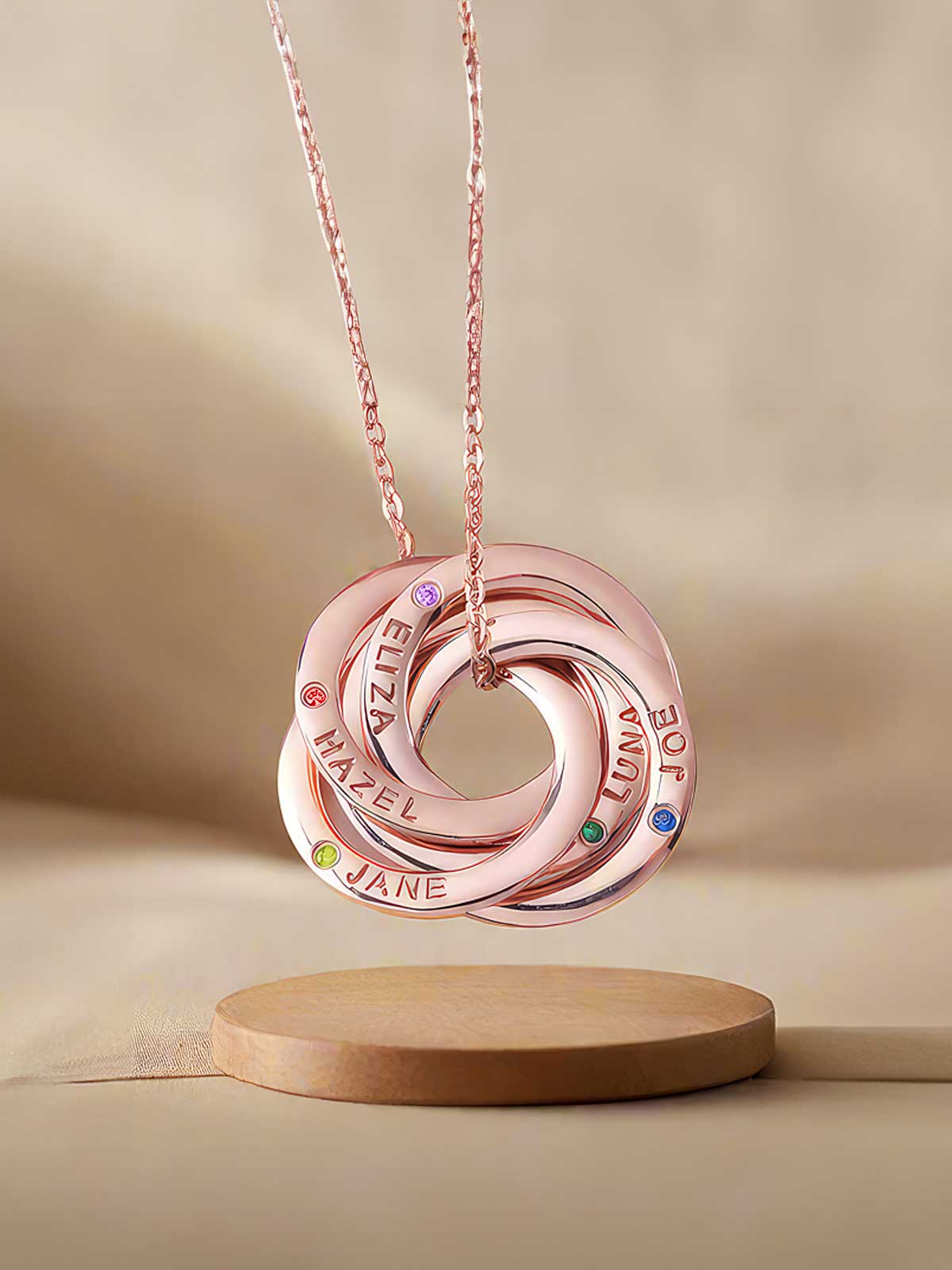 a personalized necklace on a wooden stand