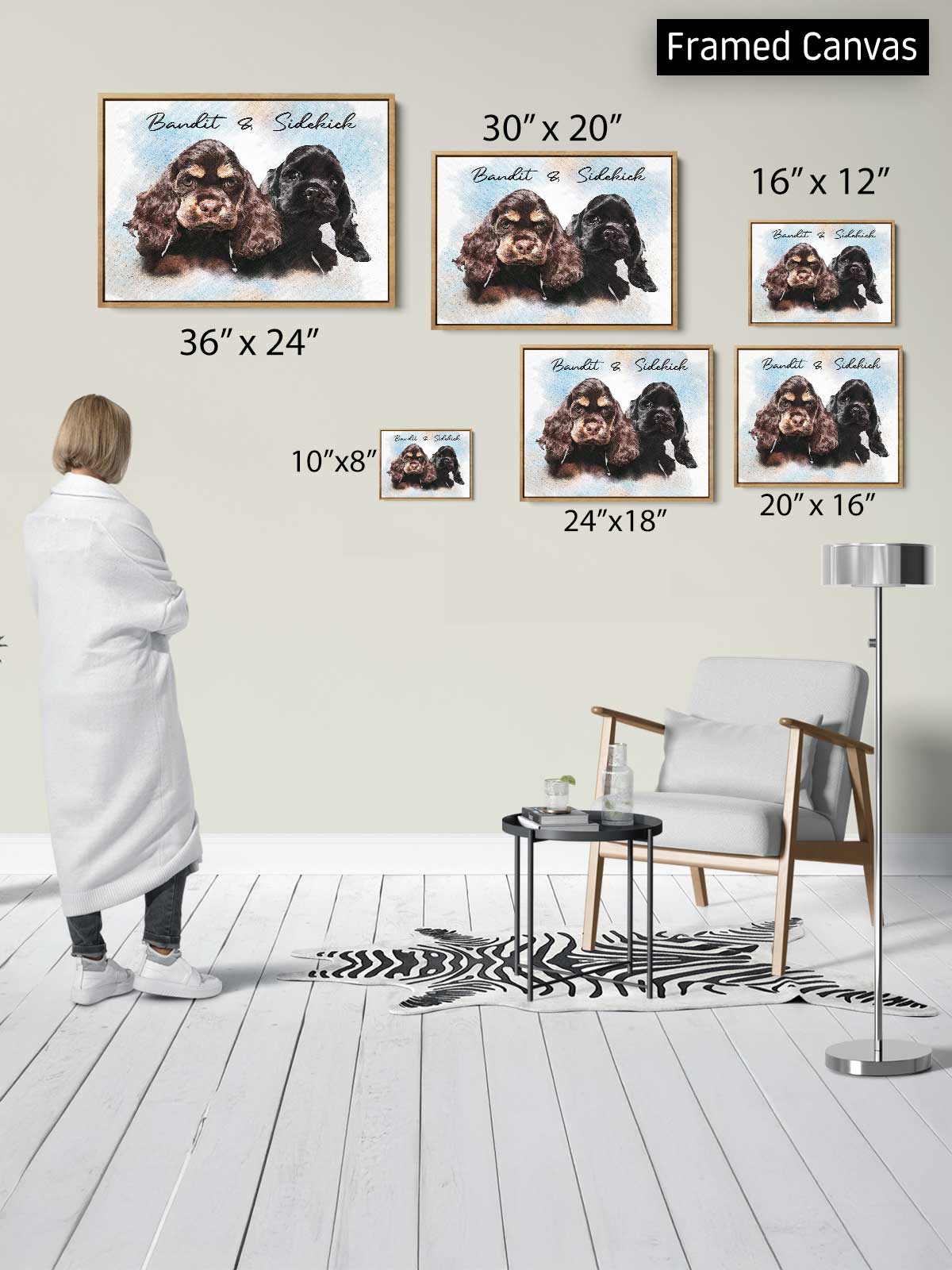 a person standing in a room with a white floor and a zebra print rug, looking at a framed canvas of two dogs. The canvas is of varying sizes, ranging from 30" x 20" to 20" x 16" and 24" x 18" to 10" x 8" and 10" x 8".