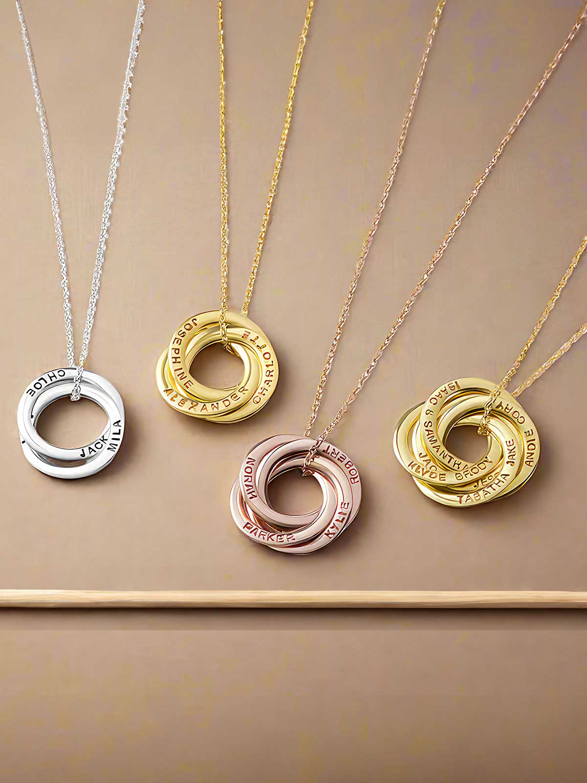 a group of three necklaces sitting on top of a table