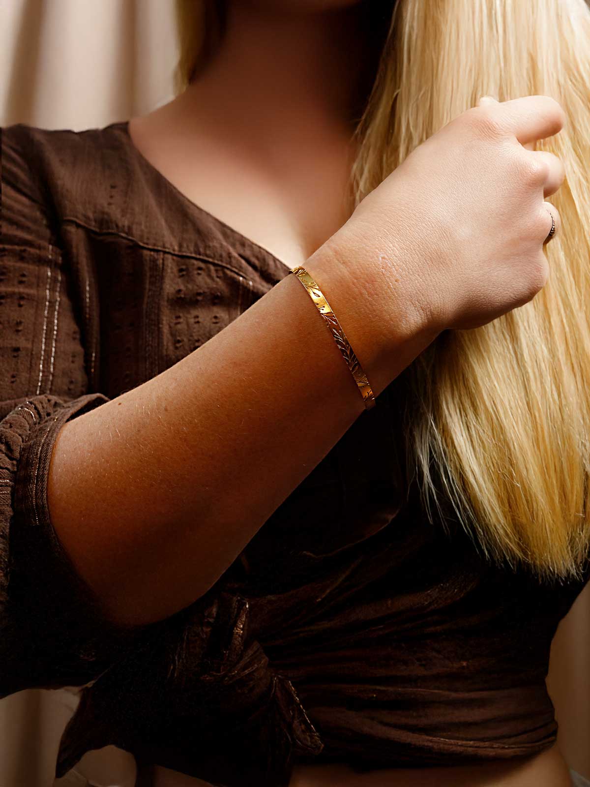 a woman holding onto a long blond hair