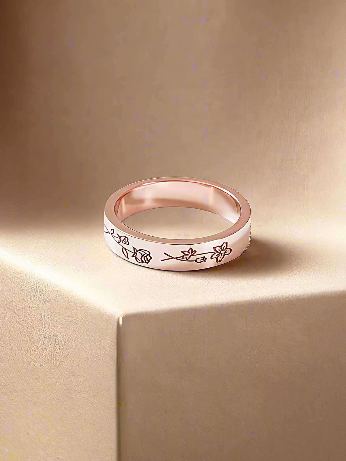 a wedding band with flowers engraved on it