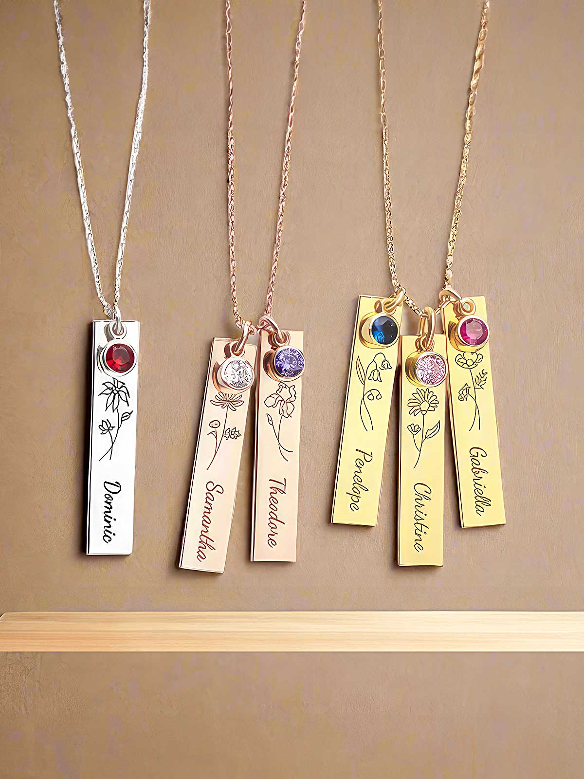 four different necklaces with names on them