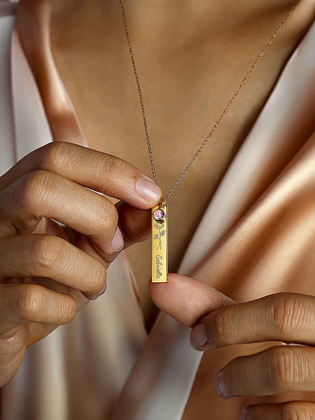 a woman wearing a necklace with a name tag on it