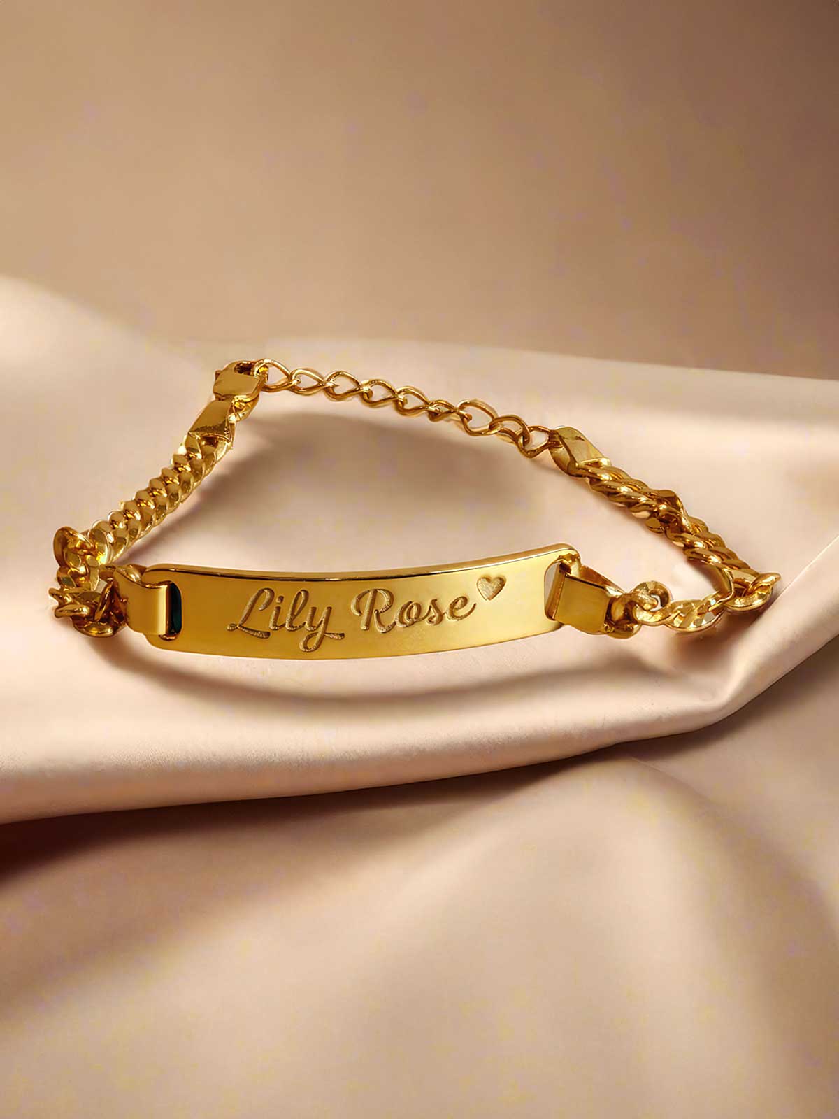 a gold bracelet with a name tag on it