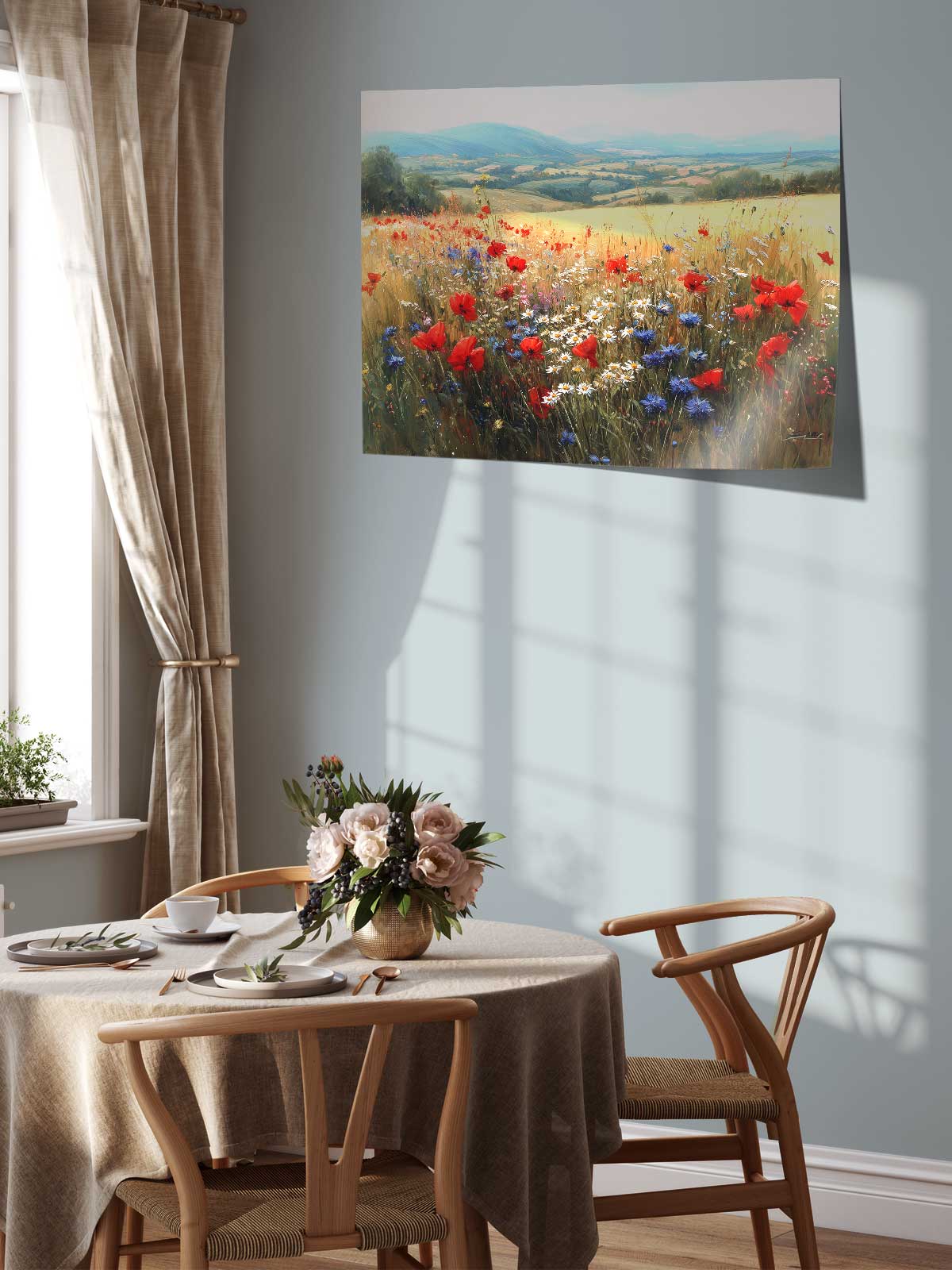 a serene dining area with a table set for two, featuring a vase of flowers and a painting of a field of red poppies and blue flowers hanging on the wall above the table.