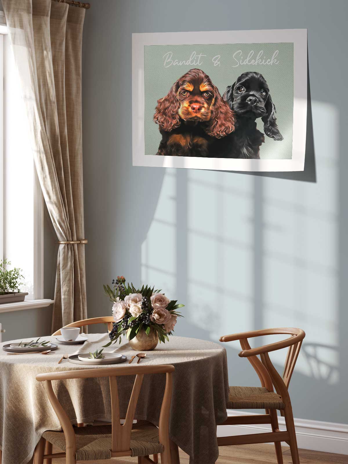 a dining area with a table set for two, featuring a vase of flowers and a framed photo of two dogs, one black and one brown, on the wall above the table.
