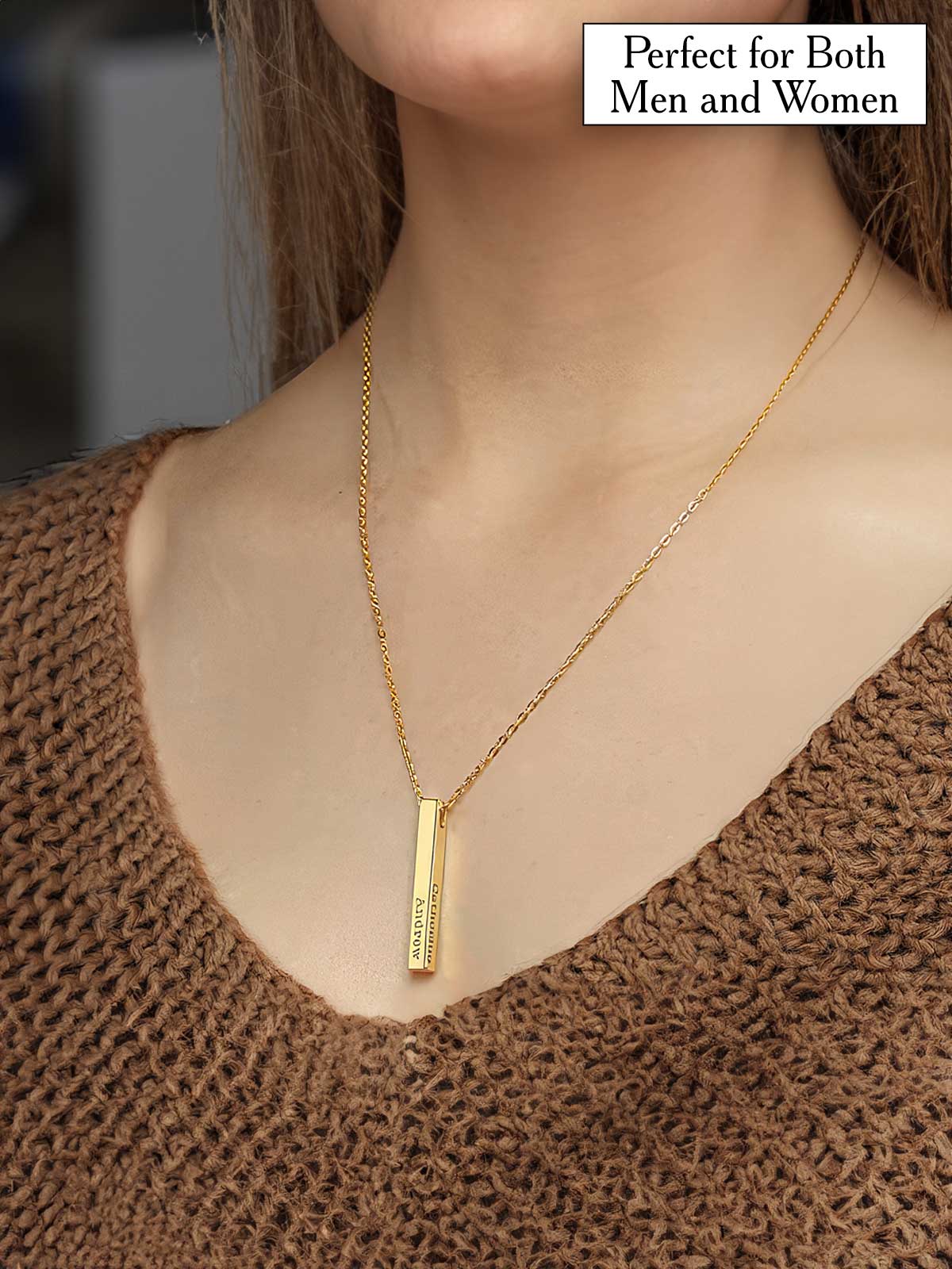 a woman wearing a gold necklace with a bar on it