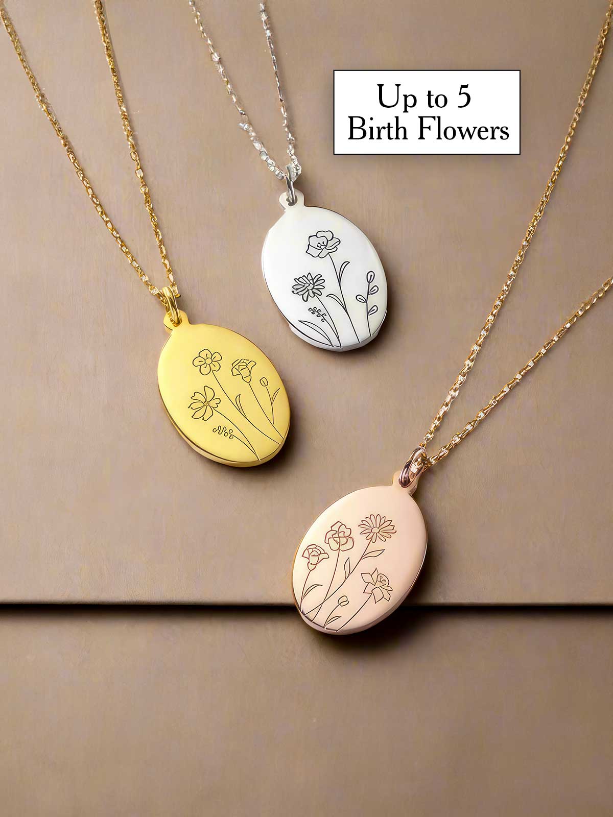 three necklaces with flowers engraved on them