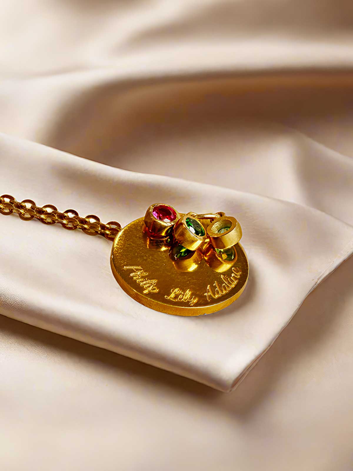 a close up of a gold necklace on a white cloth