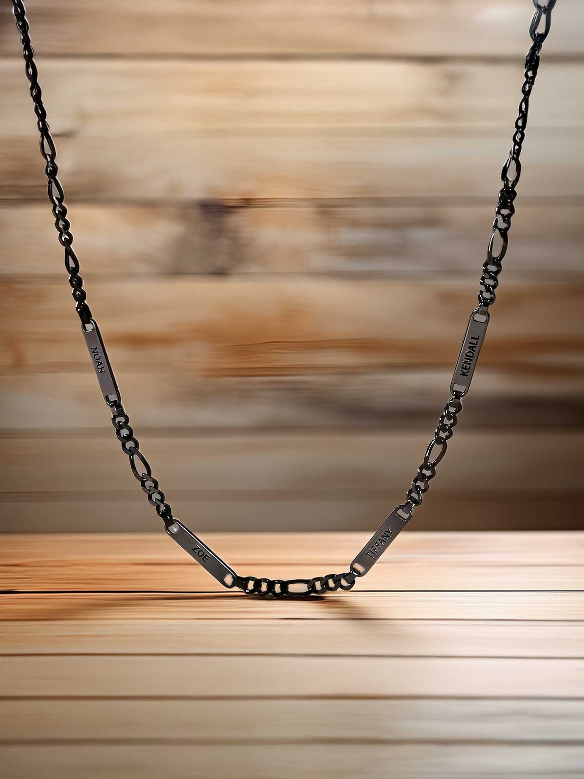 a black chain with a silver clasp on a wooden table