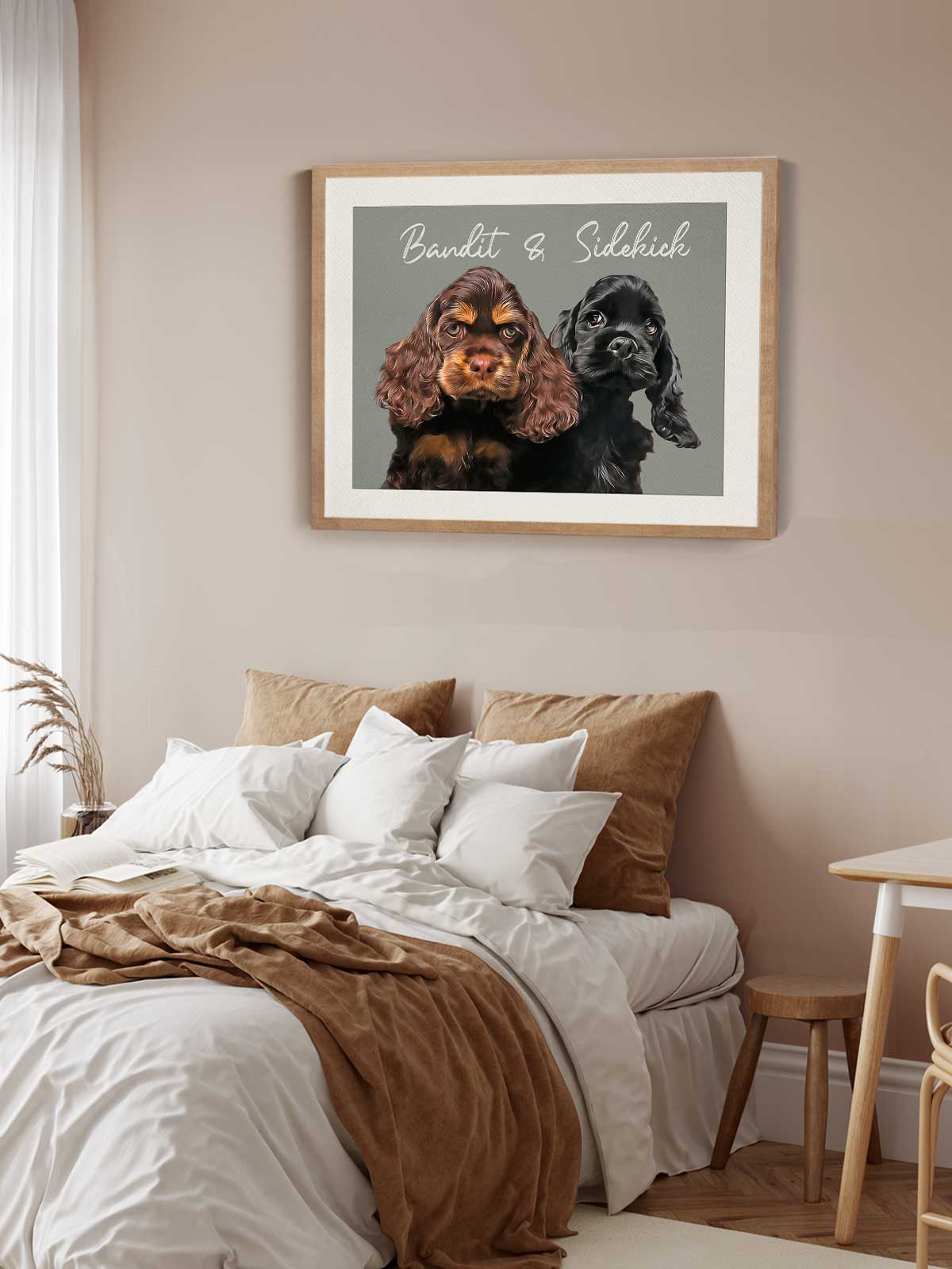 two dogs, Bandit and Sidhich, sitting together in a framed picture on a wall above a bed with white sheets and brown pillows.