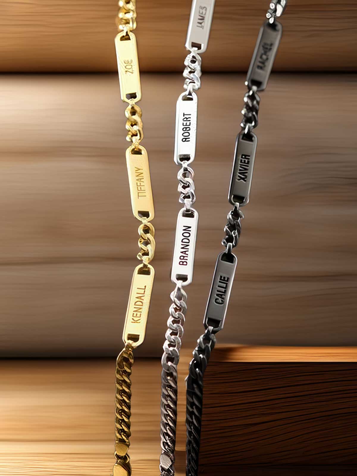 a couple of gold and silver bracelets sitting on top of a wooden table