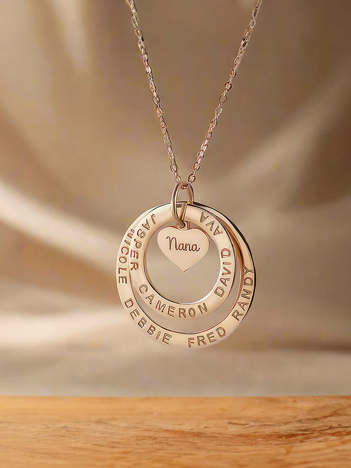 a necklace with a heart and two names on it