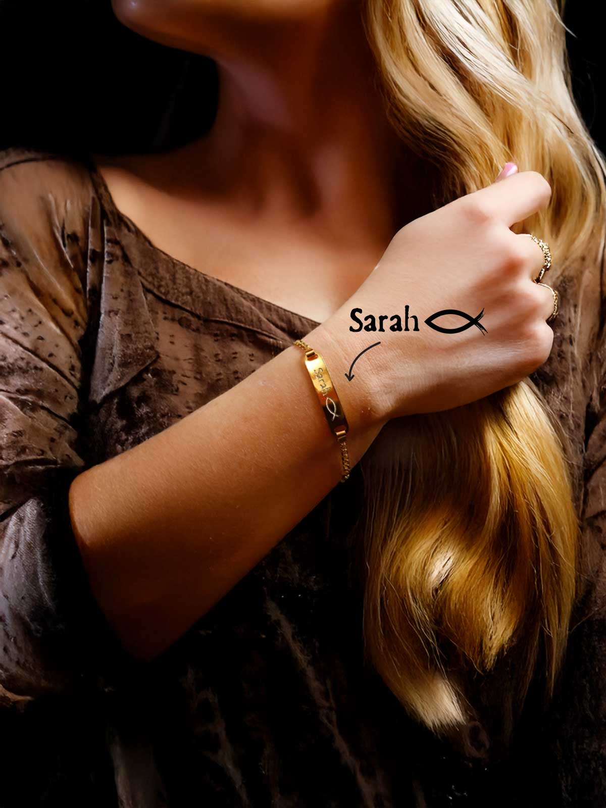 a woman wearing a bracelet with the word sarah written on it