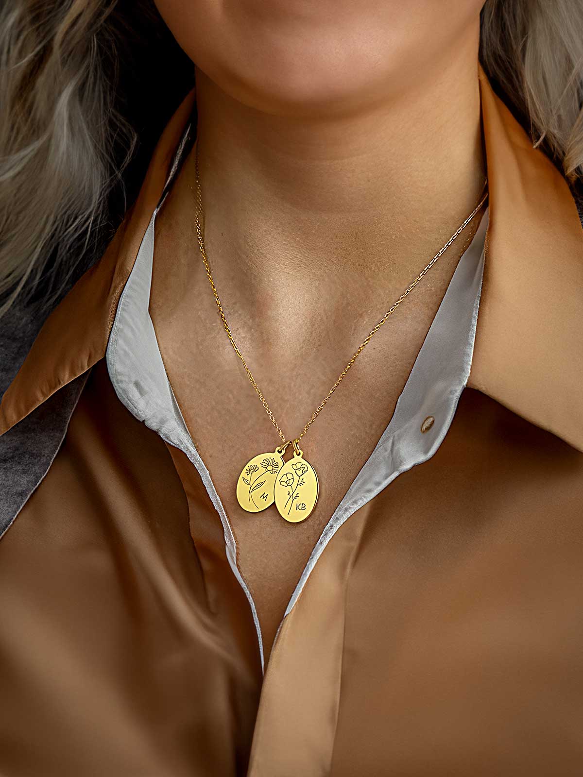 a close up of a person wearing a gold necklace