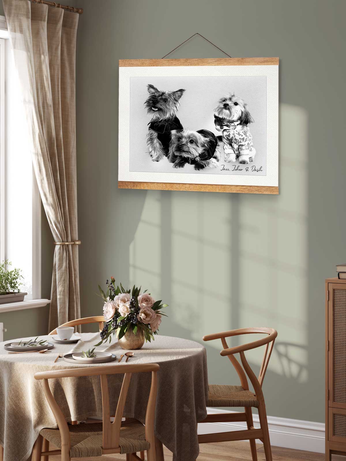 a cozy dining area with a table set for two, featuring a vase of flowers and a framed photograph of three dogs hanging on the wall above the table.