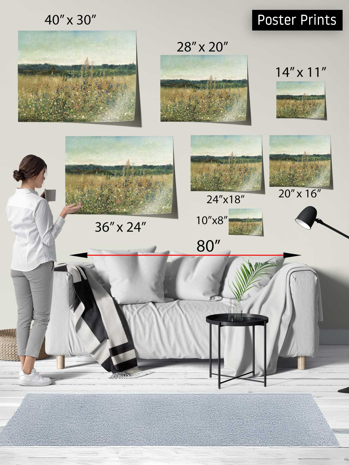 The image is a poster print display featuring a woman standing in front of a couch, with various sizes of paintings of a field displayed on the wall behind her.