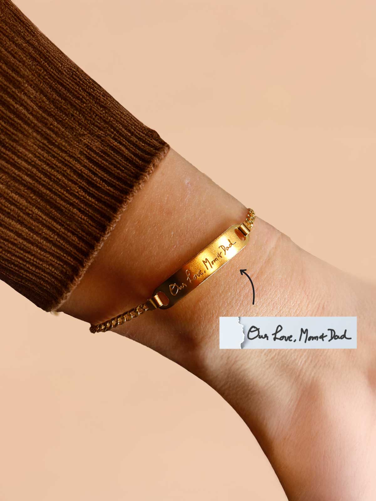 a woman's arm with a gold bracelet on it