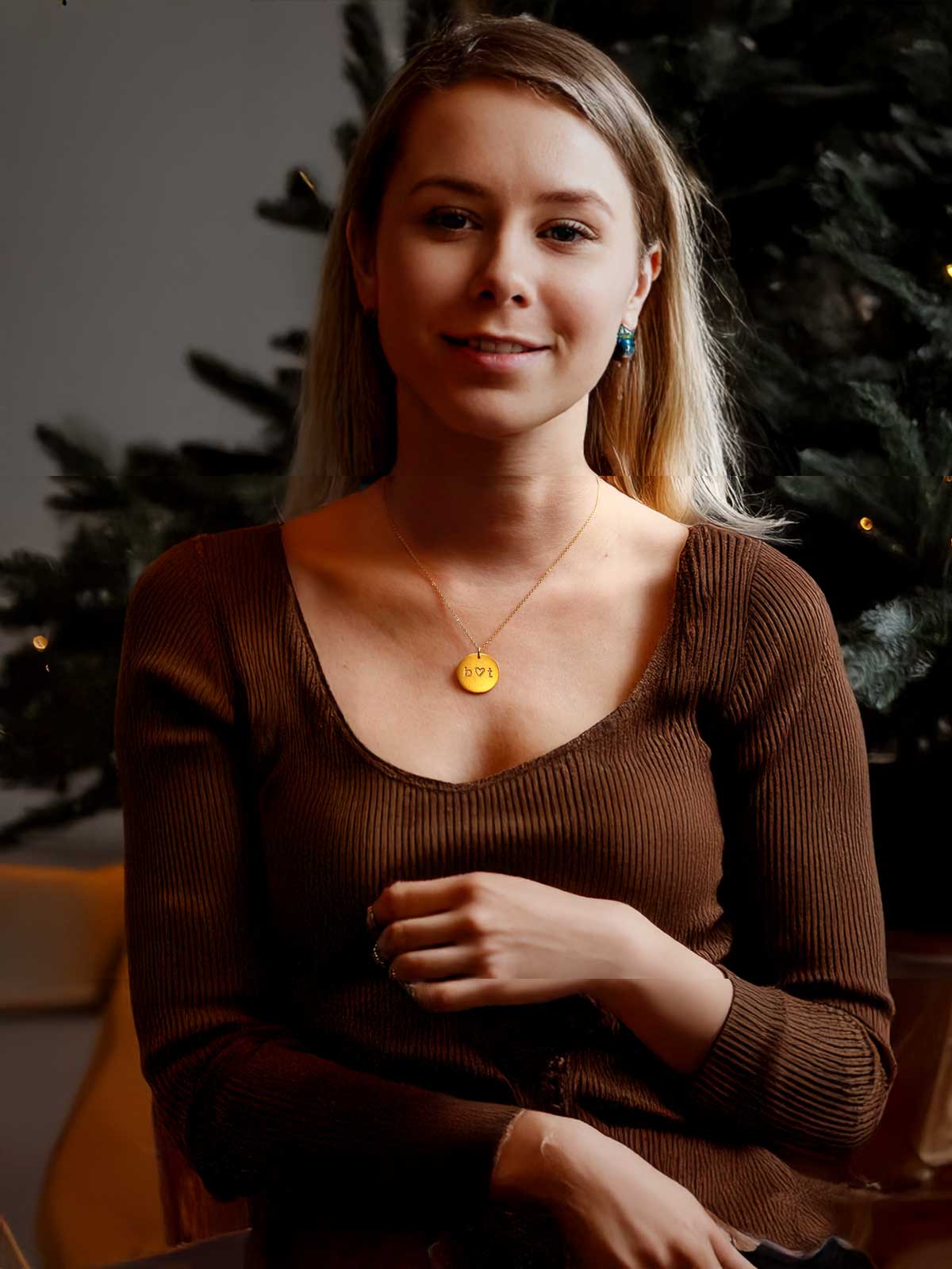 a woman sitting in front of a christmas tree