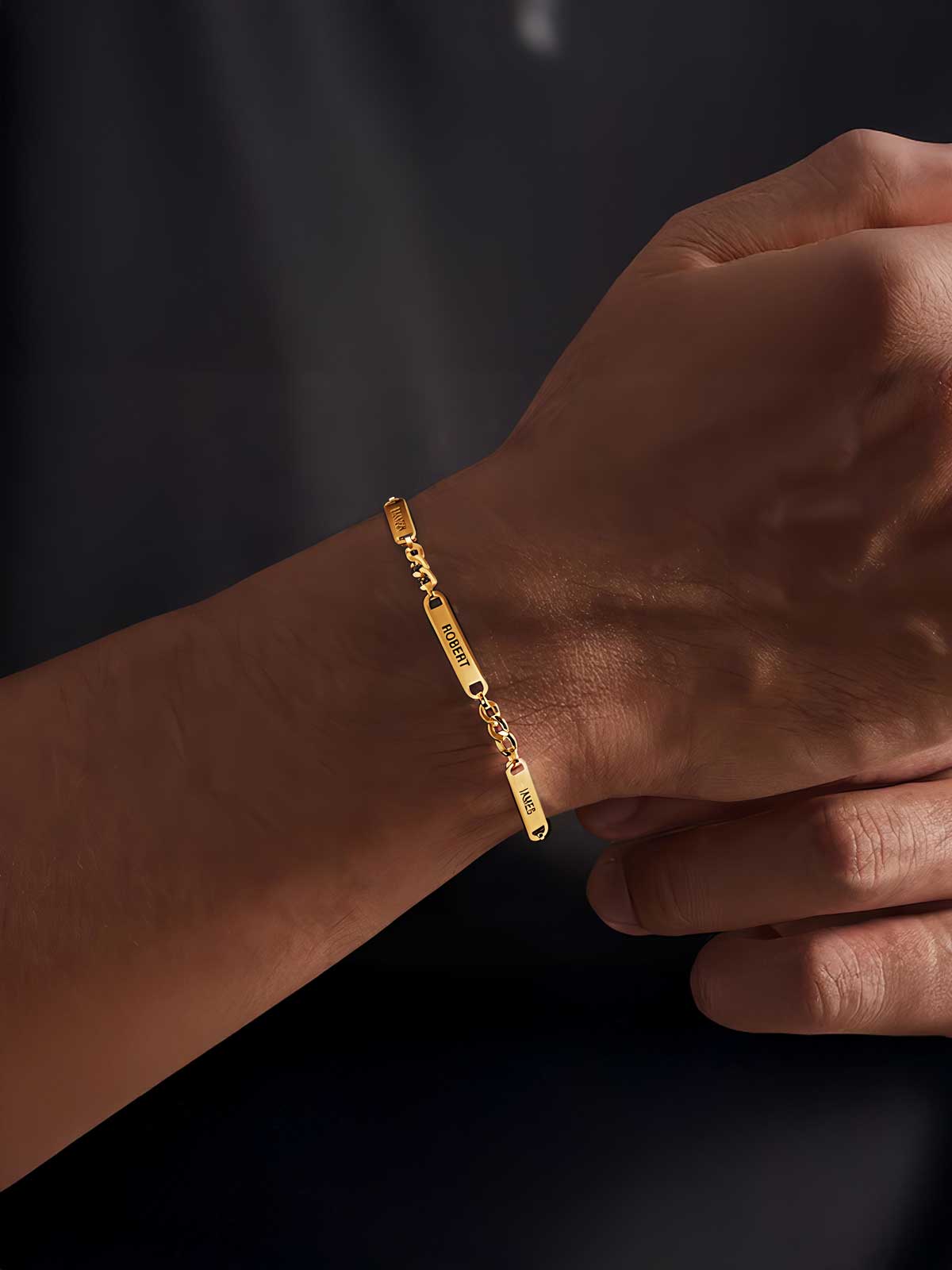 a person wearing a gold bracelet with a chain