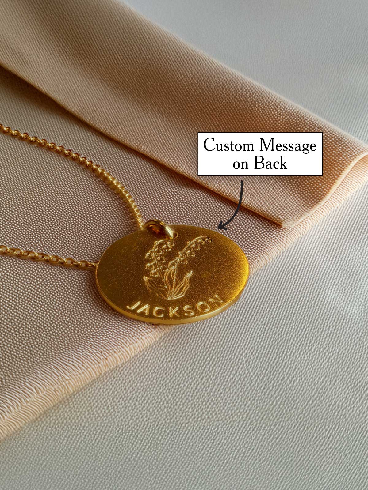 a gold necklace with a custom message on it