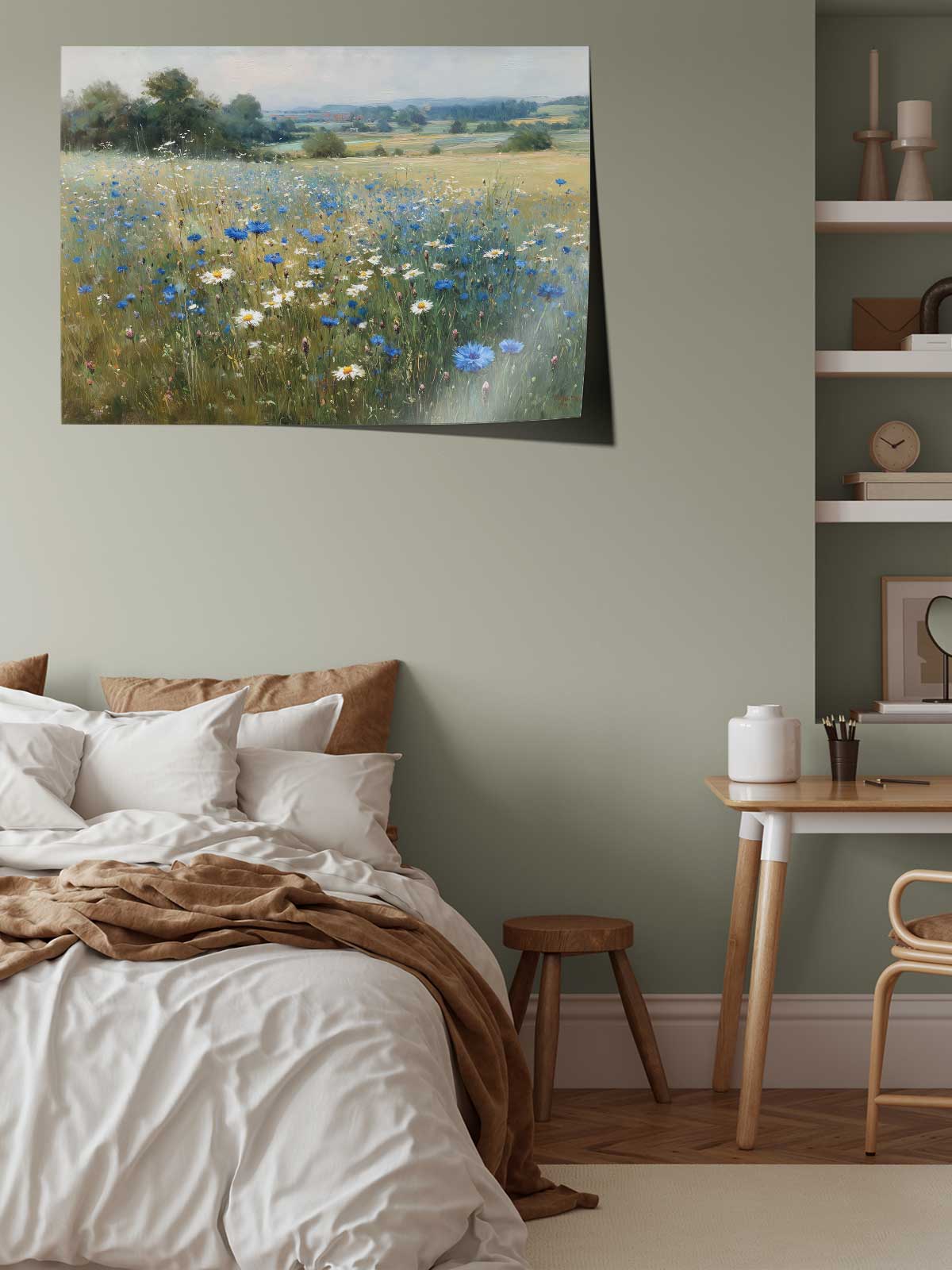 a serene bedroom scene with a large bed, a wooden table, and a painting of a field of blue and white flowers hanging on the wall.