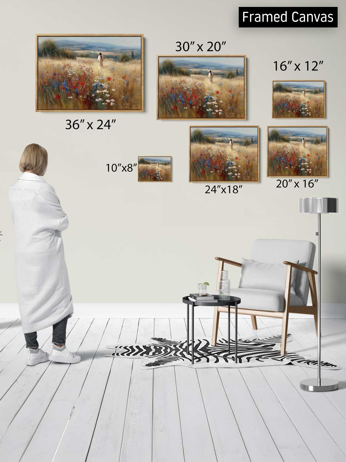 a person standing in a room with a white floor and a zebra print rug, surrounded by framed paintings of a field with flowers. The paintings vary in size, with some being larger than others. The person appears to be observing the artwork on the wall.