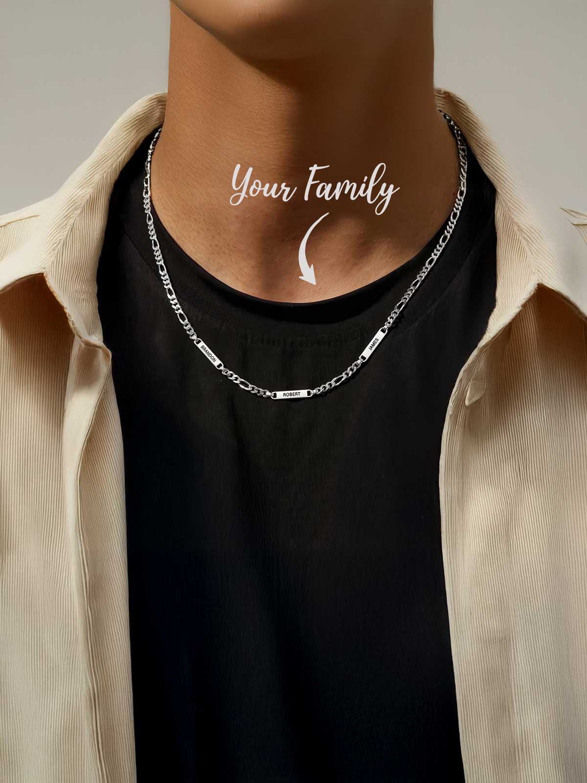 a man wearing a necklace with the words your family on it