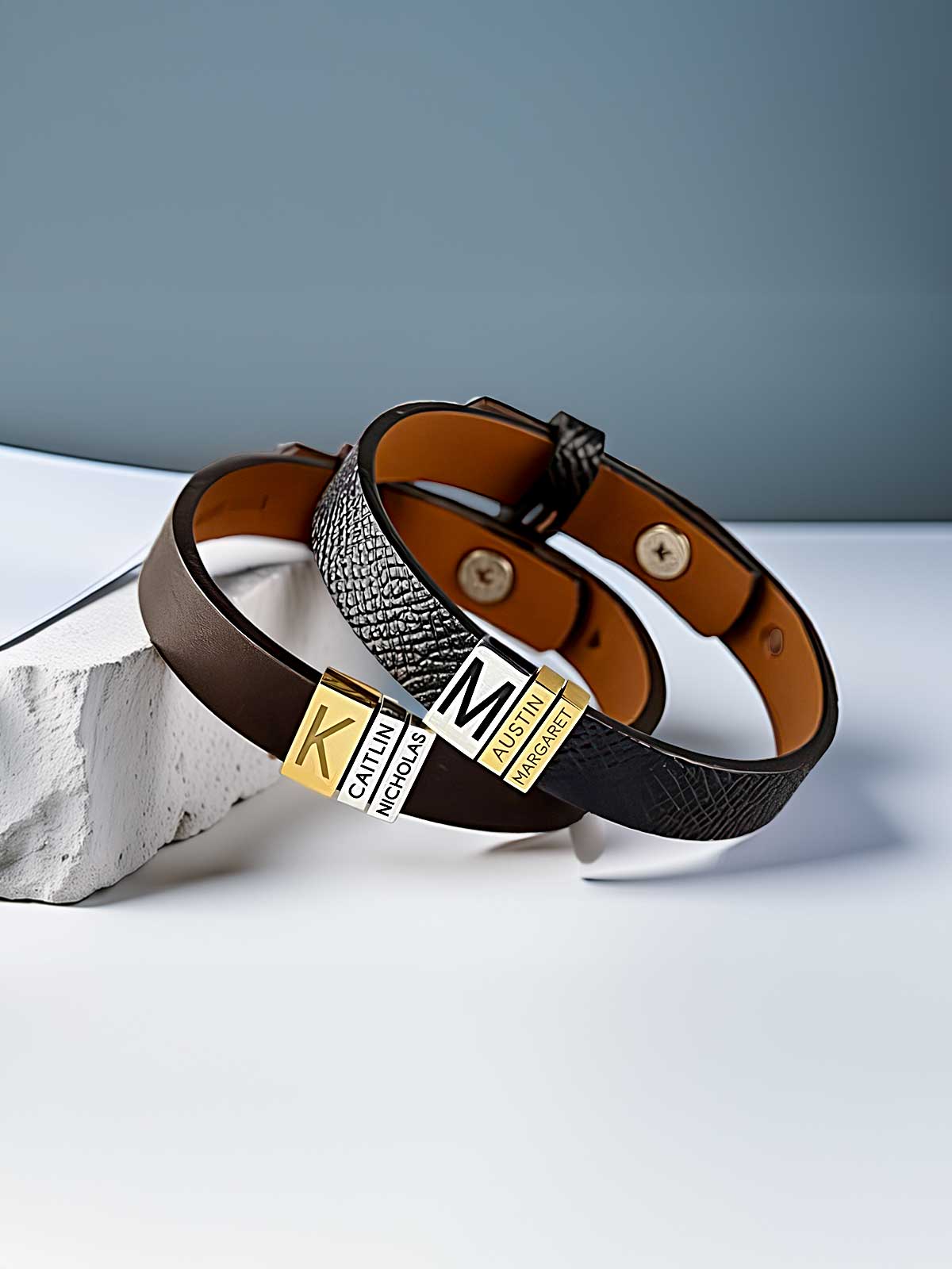a couple of belts sitting on top of a white table
