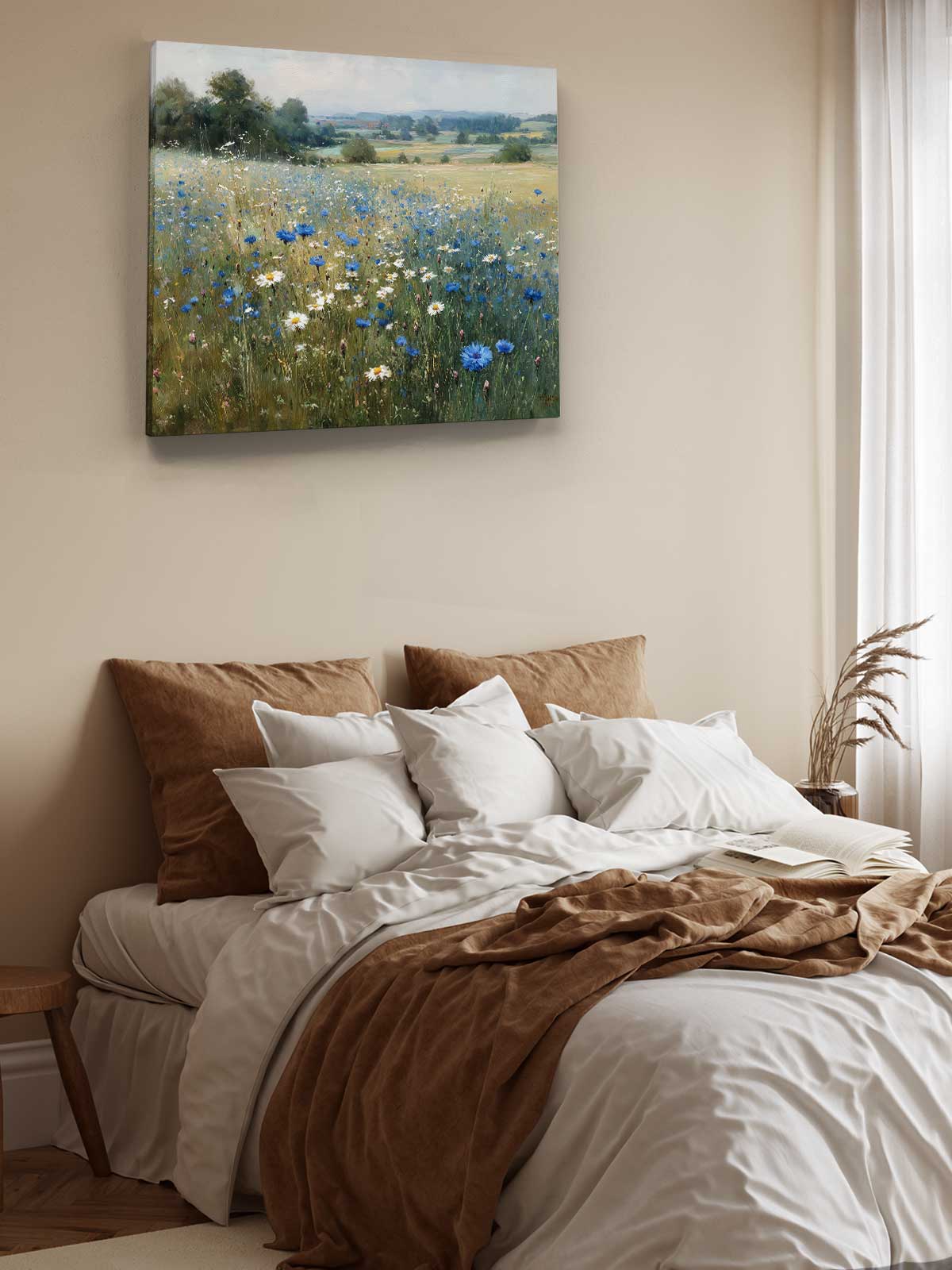 a serene bedroom scene with a bed adorned with white sheets and a brown blanket, complemented by brown pillows. Above the bed, a painting of a field filled with blue and white flowers is displayed on the wall.
