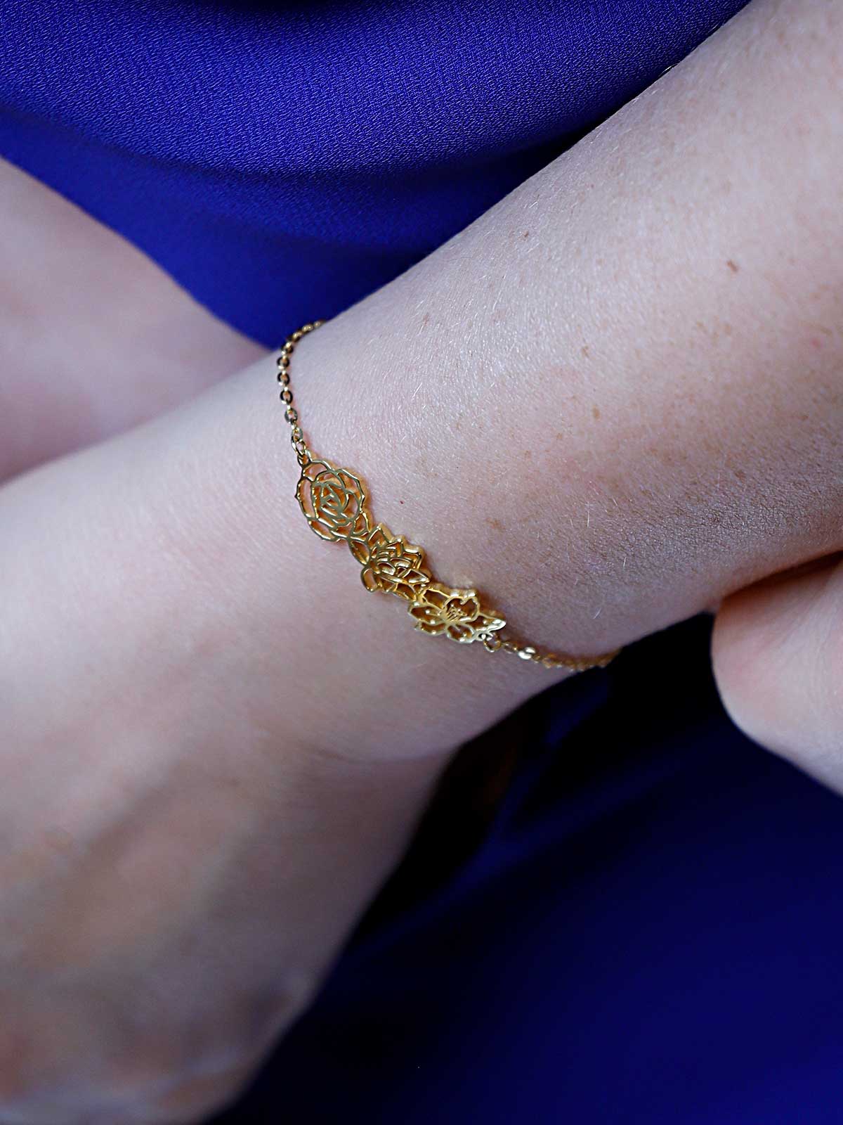 a close up of a person wearing a gold bracelet