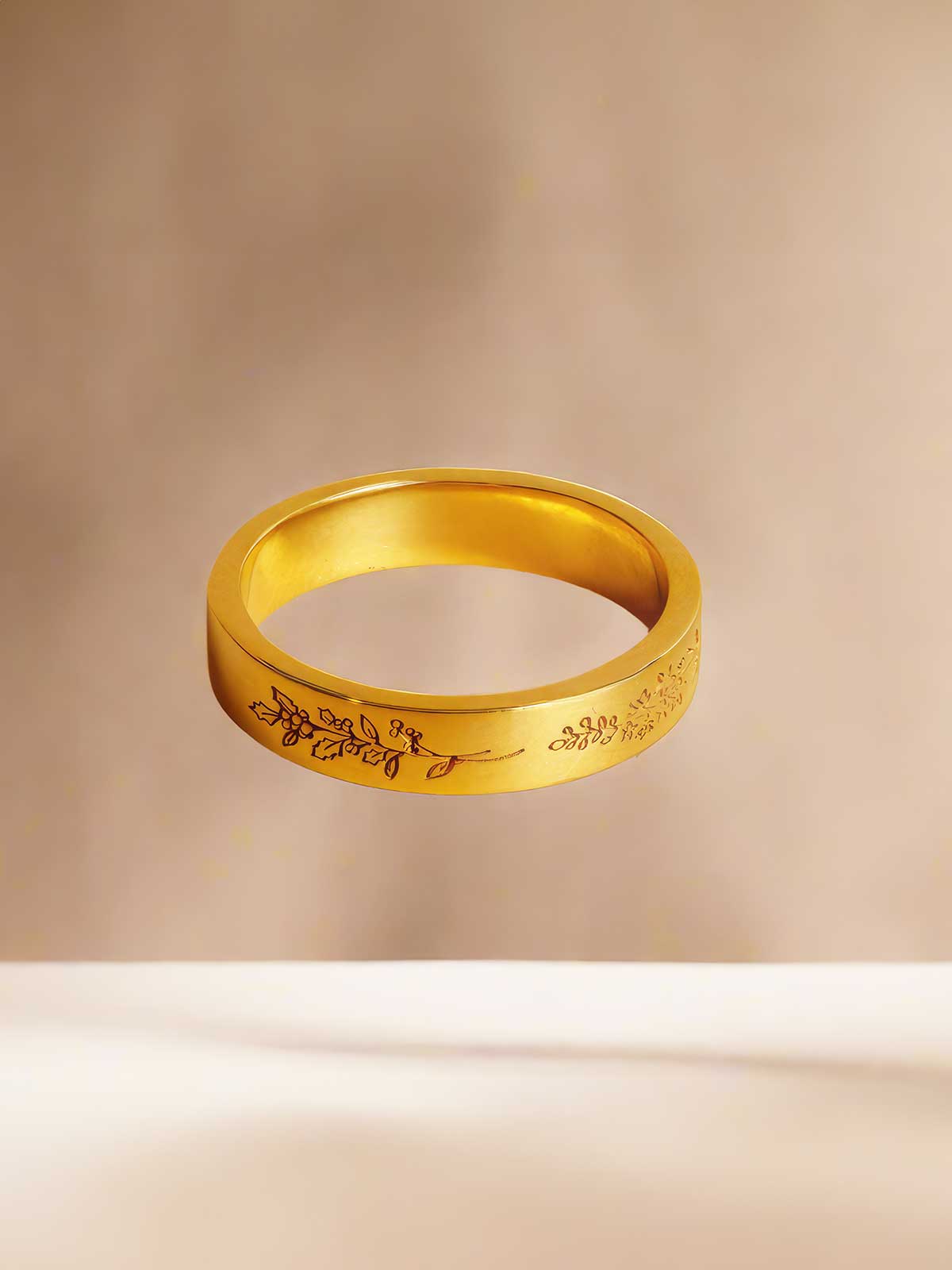 a gold ring with writing on it sitting on a table