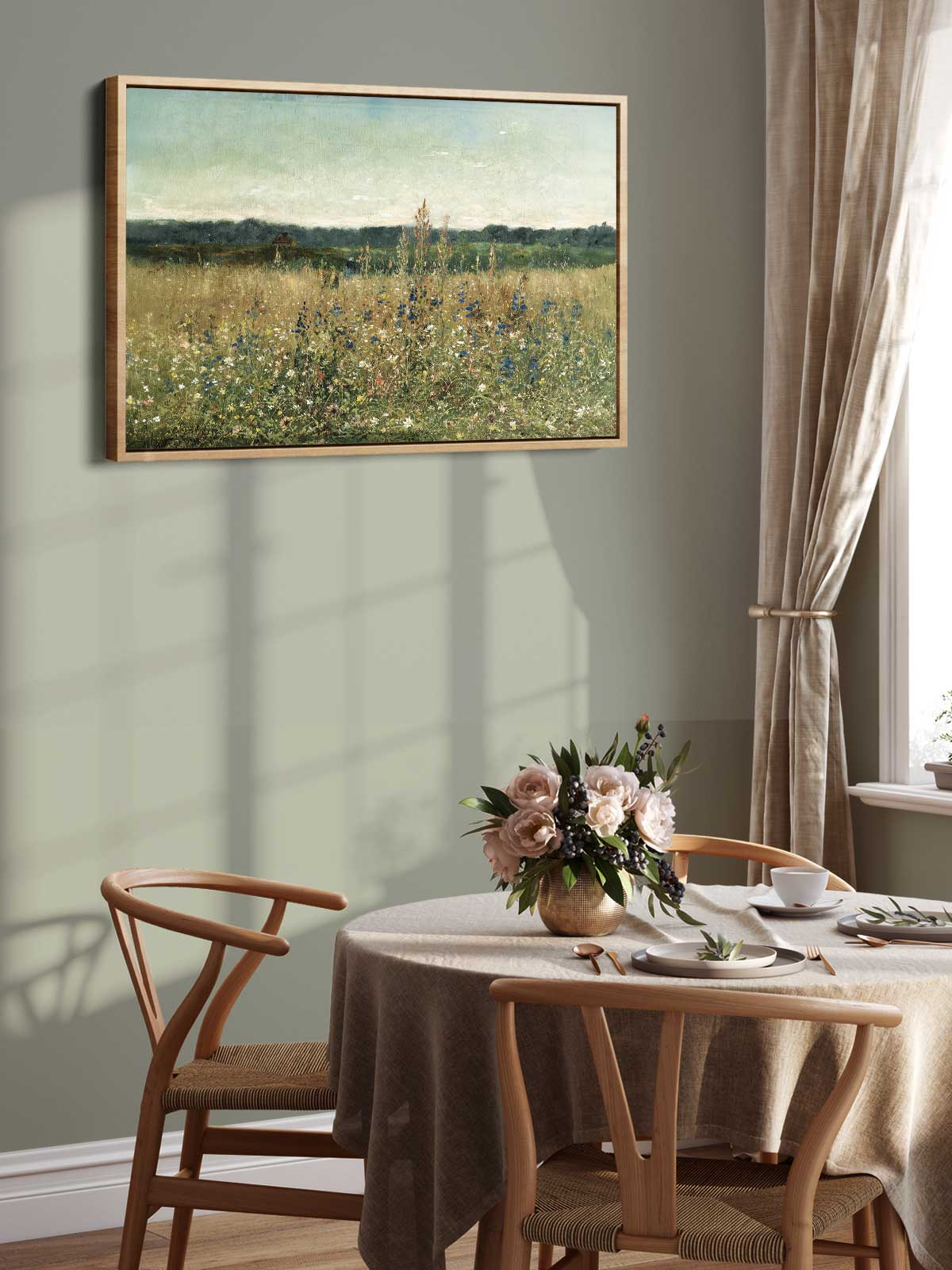 a serene dining room with a table set for two, featuring a vase of flowers and a painting of a field on the wall.